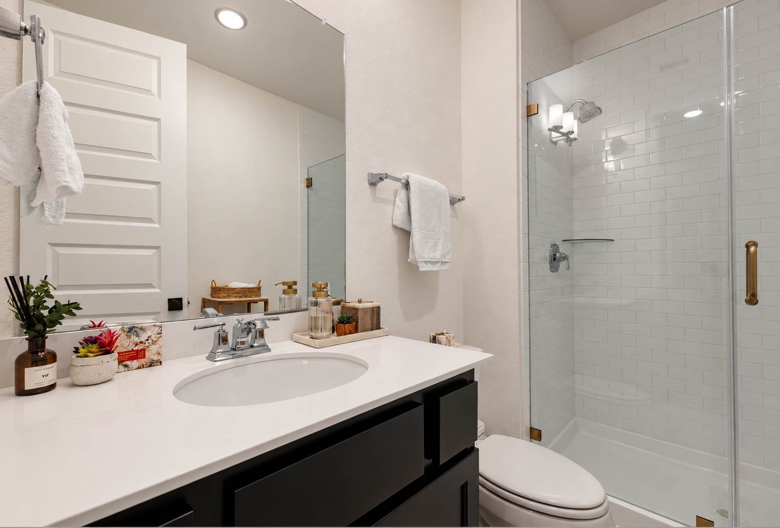 4839 Summer Place Court, Fulshear, TX 77441 Modern bathroom with a sleek vanity, spacious glass-enclosed shower, and elegant fixtures, offering a clean and inviting atmosphere.