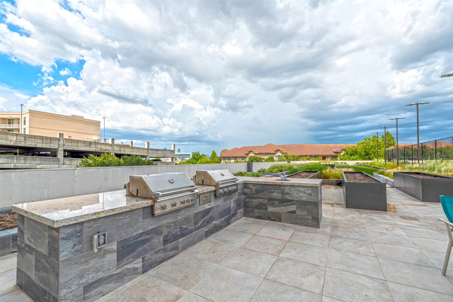 1701 Hermann Drive, #30D, Houston, TX 77004 Community grilling area with garden and outdoor seating for alfresco dining.
