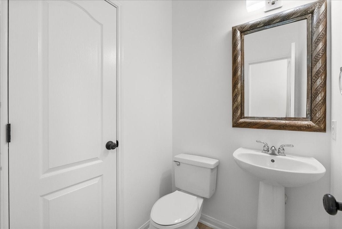 311 Lake Front Drive, League City, TX 77573 Convenient half bath for guests with a pedestal sink located on the 1st floor.