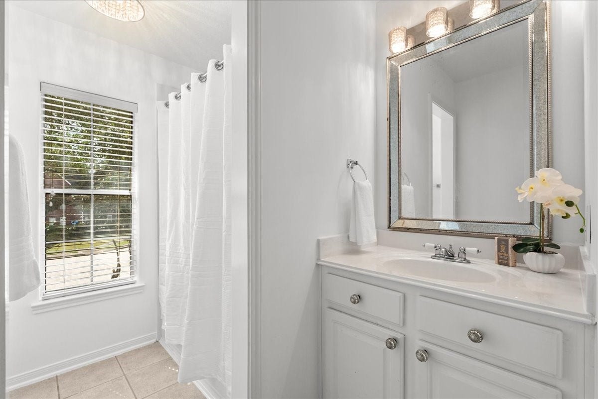 311 Lake Front Drive, League City, TX 77573 Secondary ensuite bathroom with a tub and shower combo. Added bonus and large window to let in natural light while you get ready for your day.