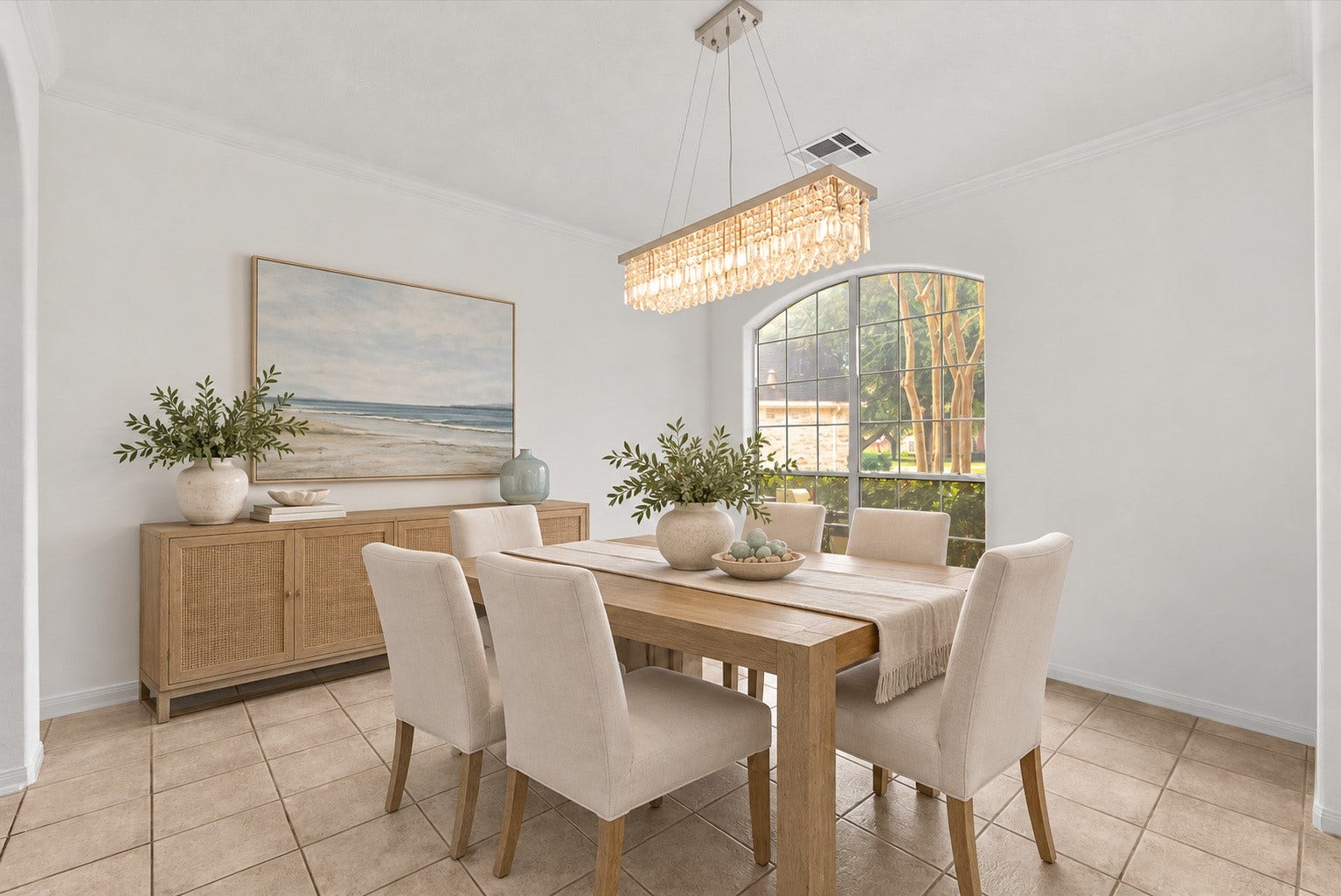 311 Lake Front Drive, League City, TX 77573 Spacious Formal dining room with a crystal chandelier and arched window. Virtually staged.