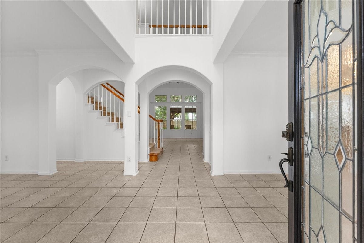311 Lake Front Drive, League City, TX 77573 Two-story entry with a stained glass front door, arched openings.