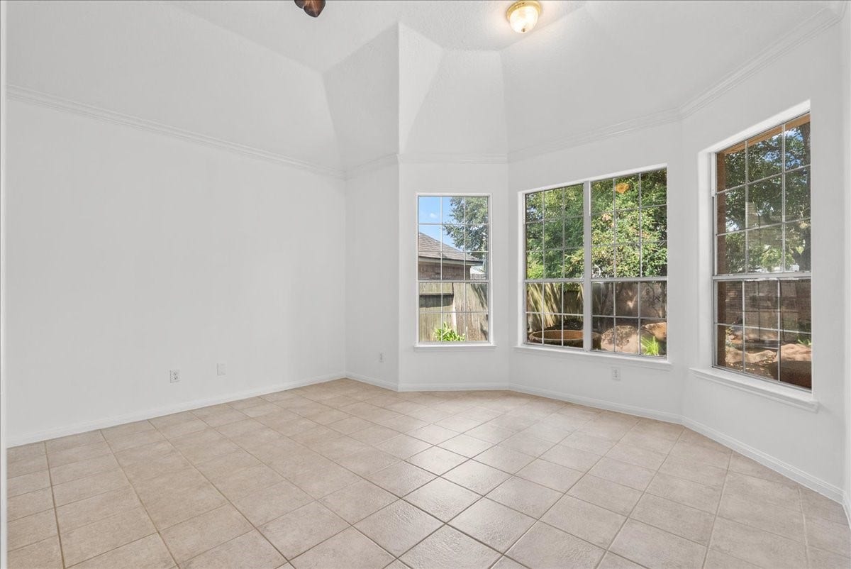 311 Lake Front Drive, League City, TX 77573 Tranquil primary bedroom with a bay window sitting area overlooking the backyard.