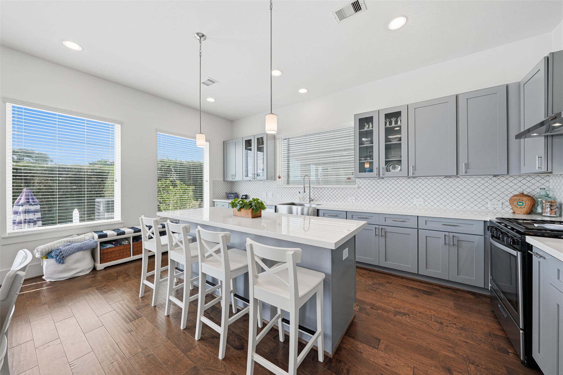 Sleek, modern kitchen with island seating, quartzite countertops and plenty of cabinet space.