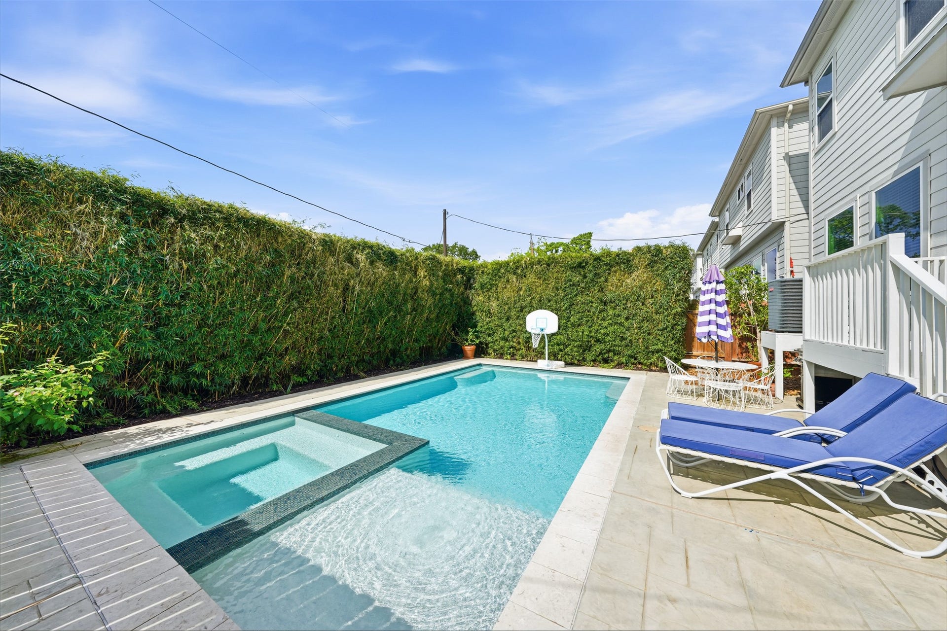 Enjoy the custom full-sized pool and hot tub with bamboo added for privacy.