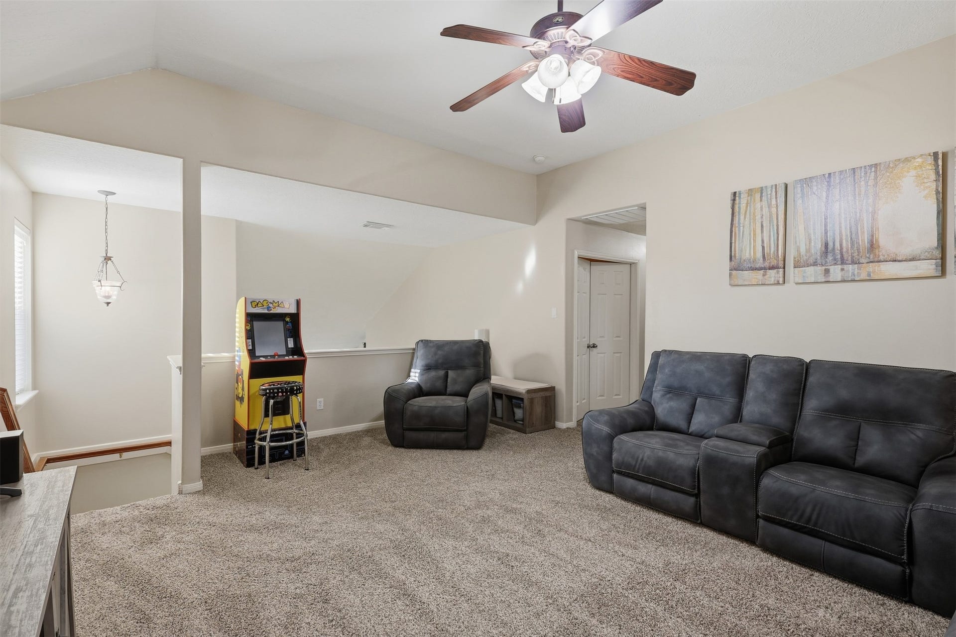 11404 Summit Bay Drive, Pearland, TX 77584 Spacious upstairs game room provides a comfortable and versatile retreat with plush carpeting, ceiling fan, comfortable seating, and plenty of room for recreation and entertaining. A bright, open space ready for family game nights and casual gatherings.
