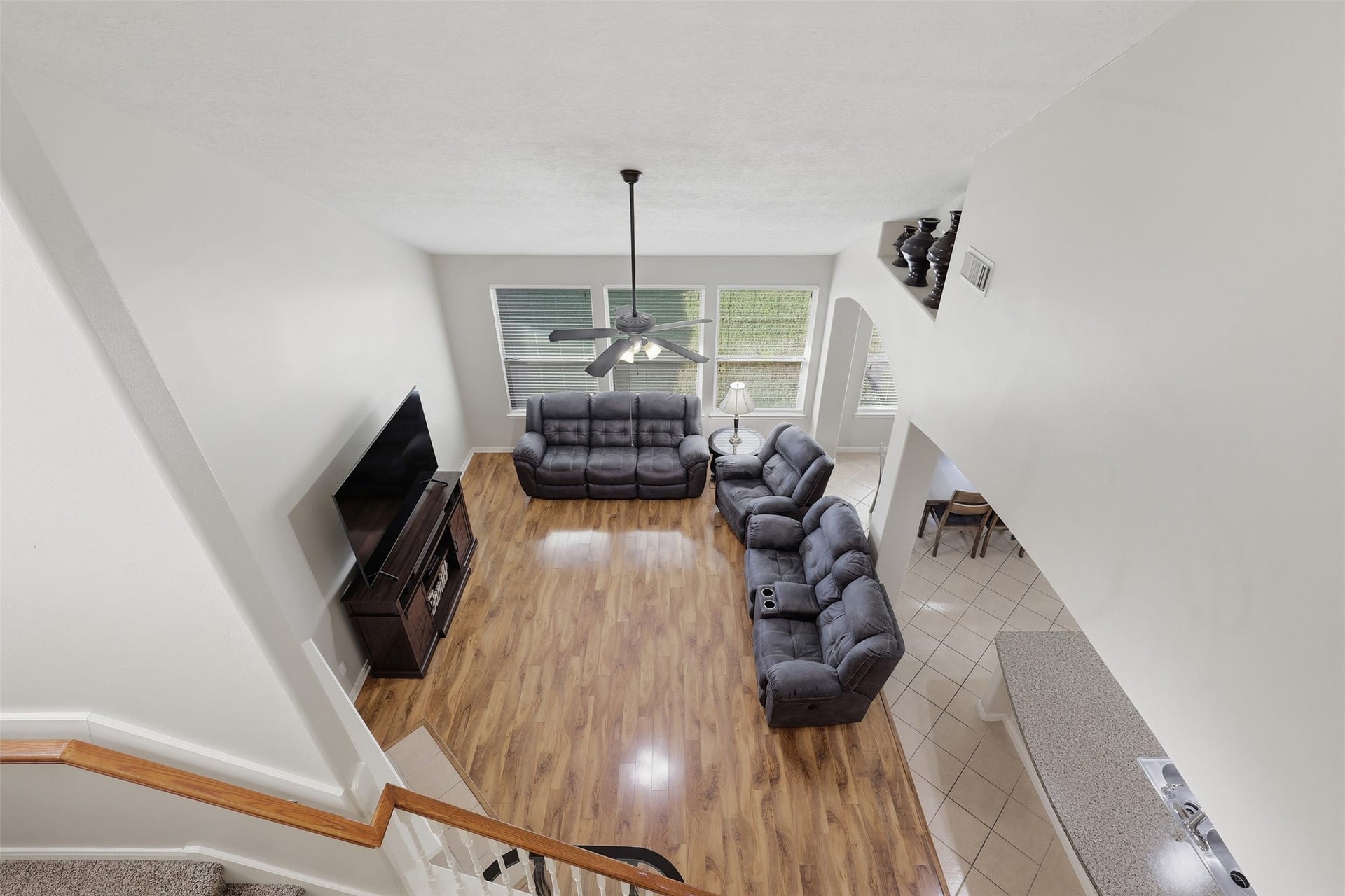 11404 Summit Bay Drive, Pearland, TX 77584 Fabulous second-floor game room overlooks the spacious family room below, creating an impressive open and connected feel. Beautiful wood-look flooring, abundant natural light, and generous space make this an ideal area for games, entertaining, or family fun.