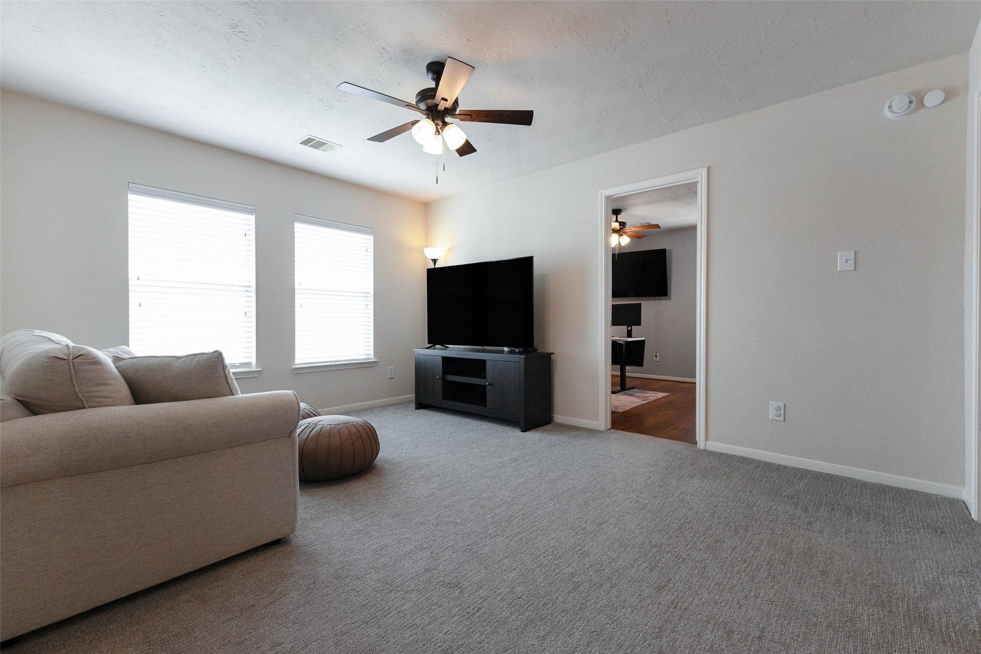 A second perspective emphasizes the game rooms open dimensions and versatility. Multiple windows brighten the space, while its neutral finishes make it easy to customize as a media room, playroom, or casual upstairs lounge.