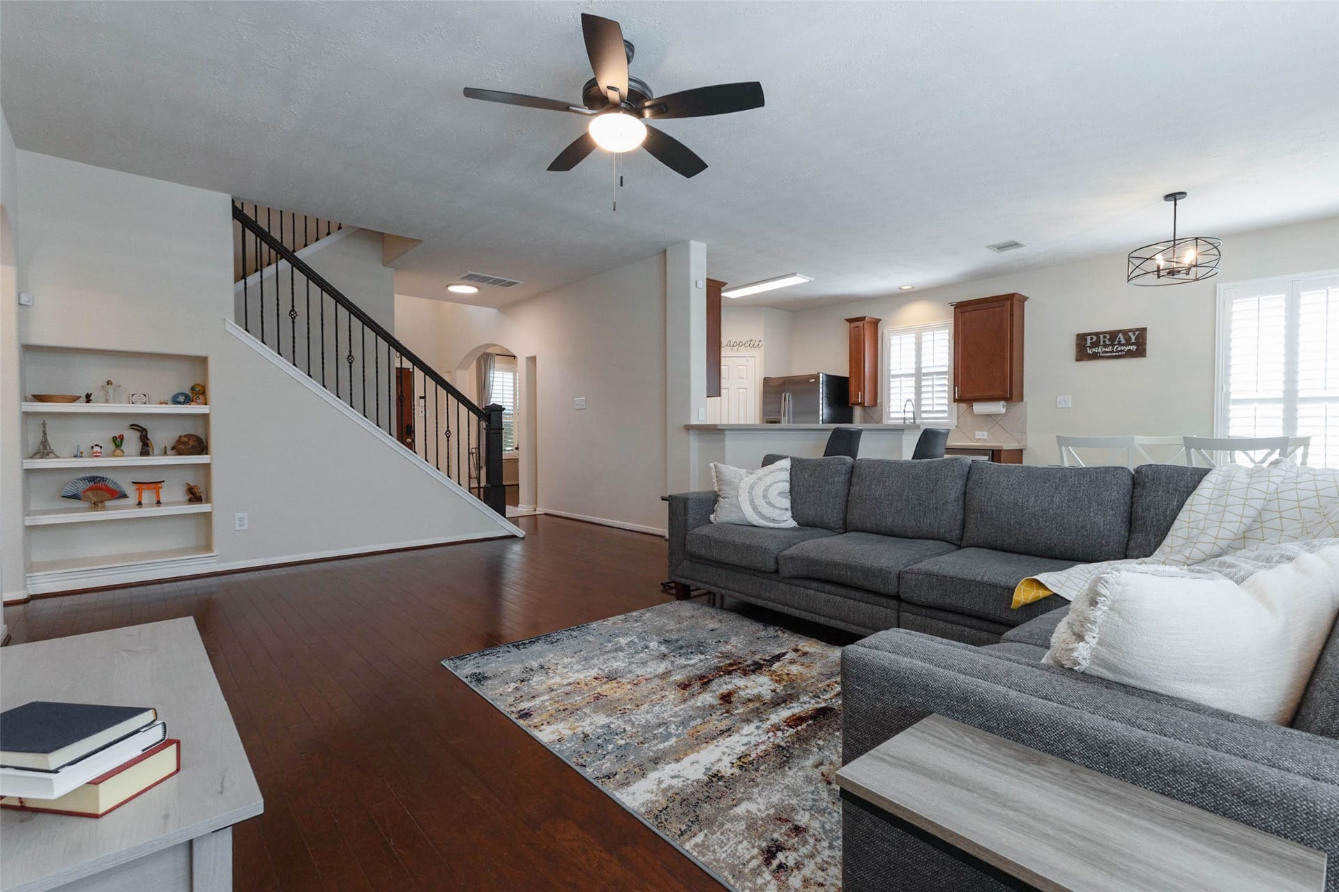 This wide-angle perspective beautifully showcases the homes connected layout. The expansive family room flows naturally into the kitchen and breakfast area, creating easy sightlines and a comfortable arrangement for everyday living and entertaining.
