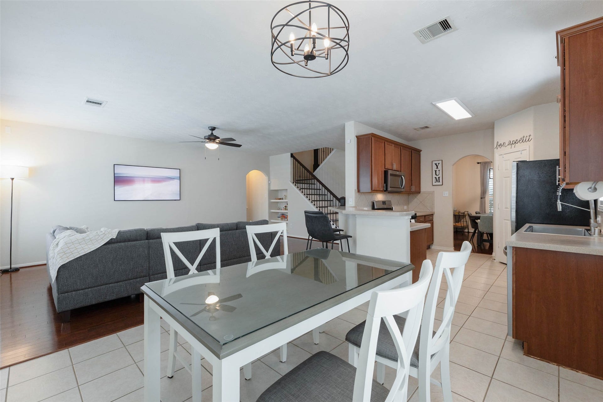 Looking from the breakfast area, this perspective captures the effortless connection between the kitchen and family room. The open arrangement keeps the main gathering spaces visually connected while still giving each area its own defined purpose.