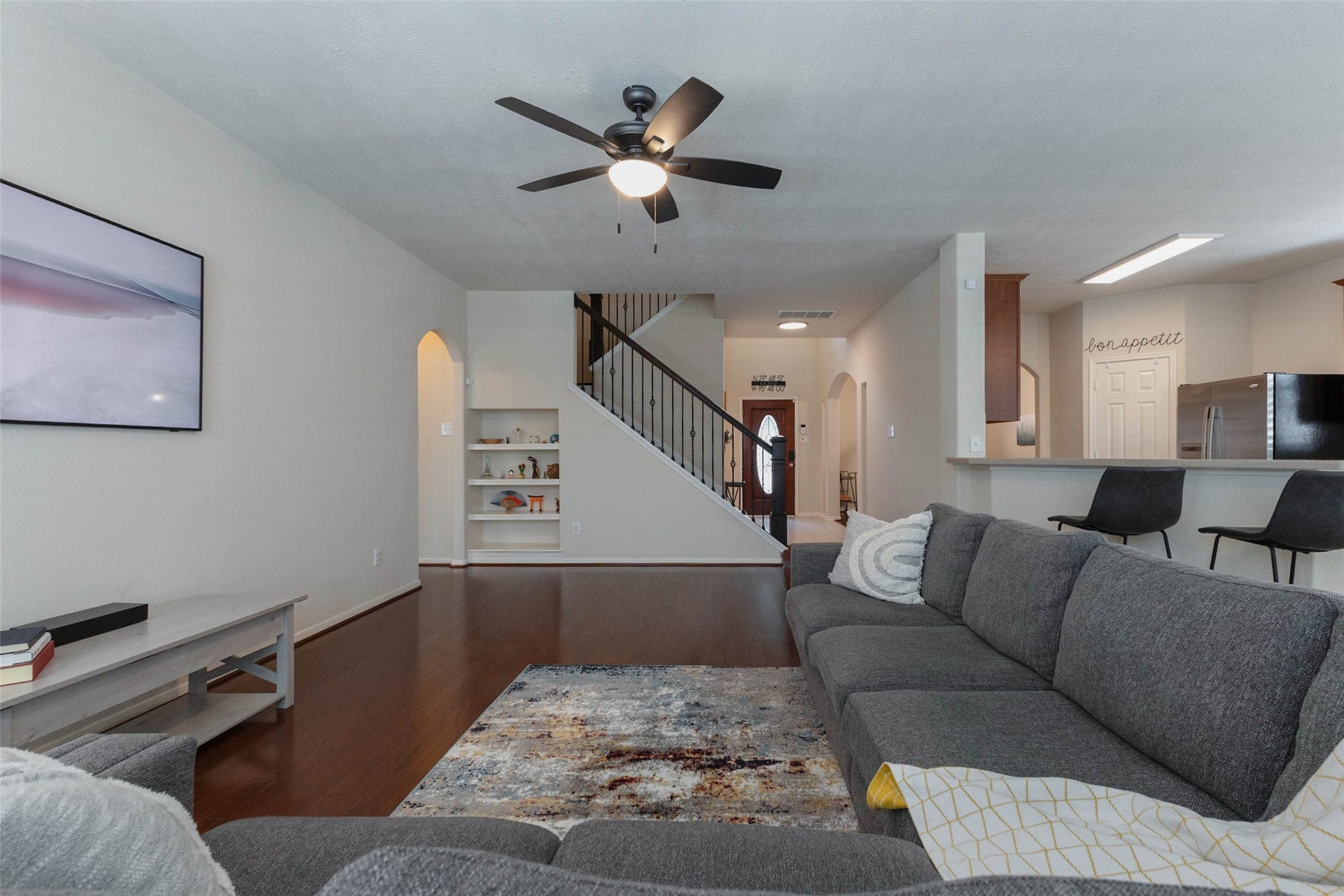 Another perspective emphasizes the family rooms generous scale and open sightlines toward the entry, staircase, and kitchen. The long wall offers an ideal location for an entertainment center, while the open layout provides plenty of flexibility for multiple seating arrangements.
