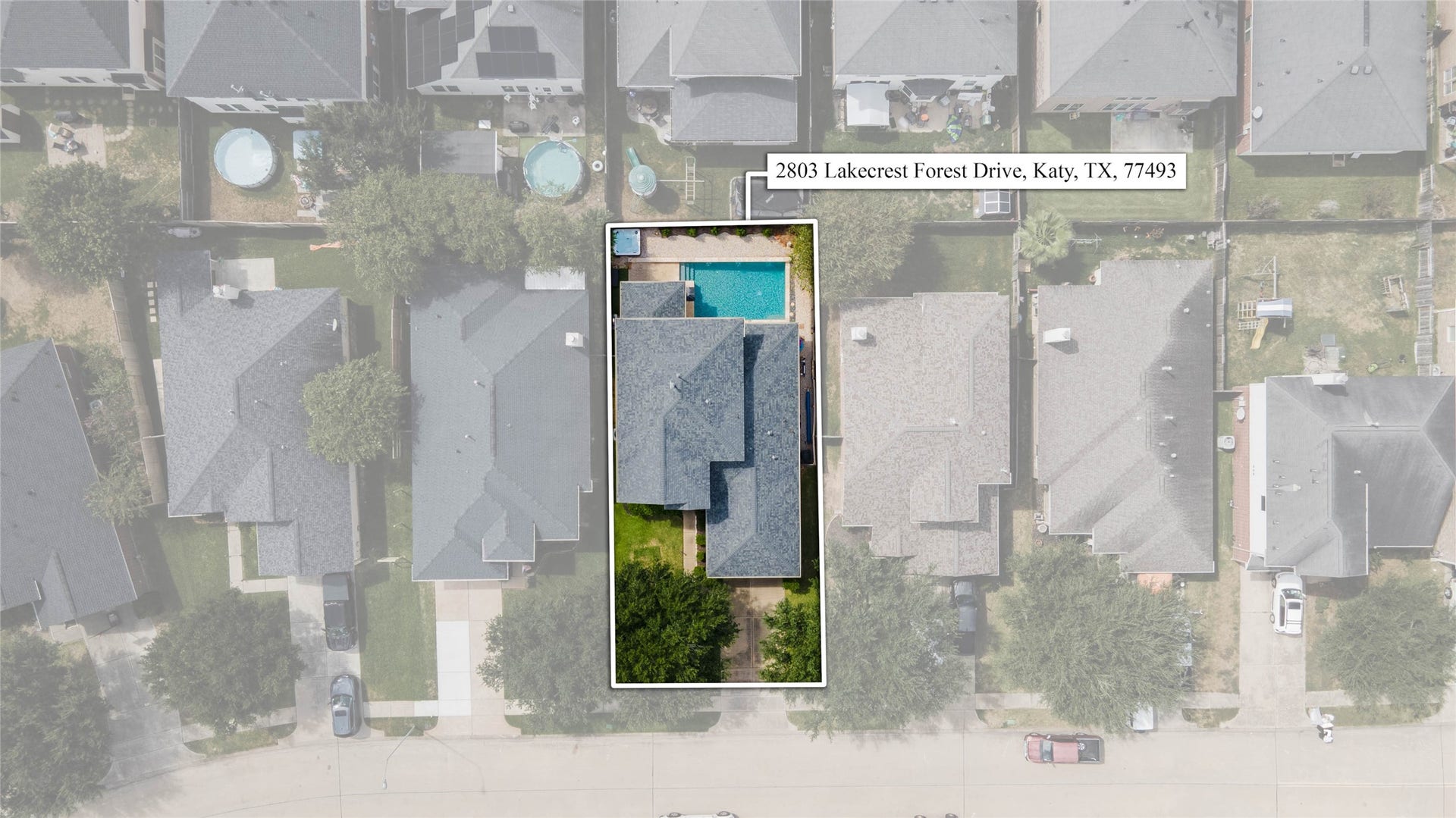 The overhead aerial clearly outlines the homesite and provides an excellent perspective on the placement of the residence, driveway, backyard, and swimming pool within the property.