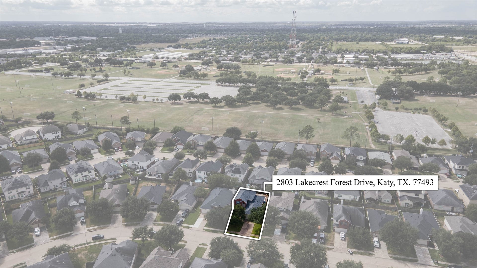 An elevated perspective showcases the homes setting within the established neighborhood, surrounded by residential streets, mature landscaping, and nearby green space.