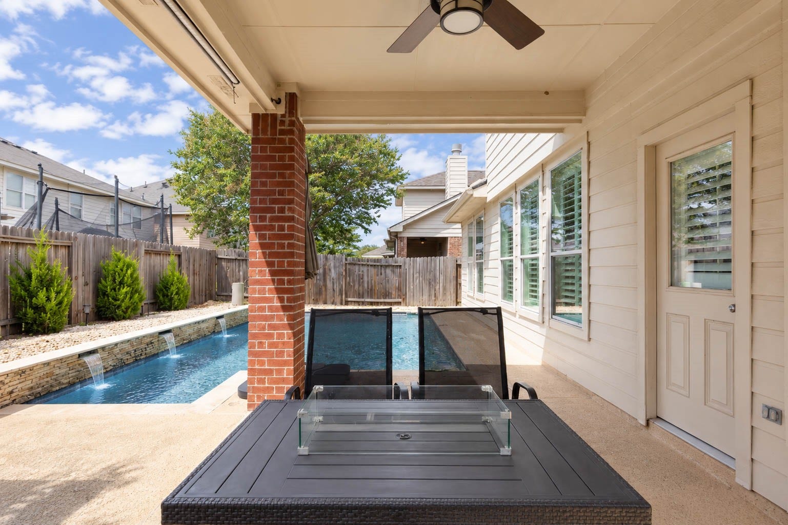 From beneath the covered patio, enjoy a comfortable place to relax while staying connected to all the backyard activity. A ceiling fan adds comfort overhead, while direct access to the home makes this sheltered outdoor space a natural extension of the interior living areas.