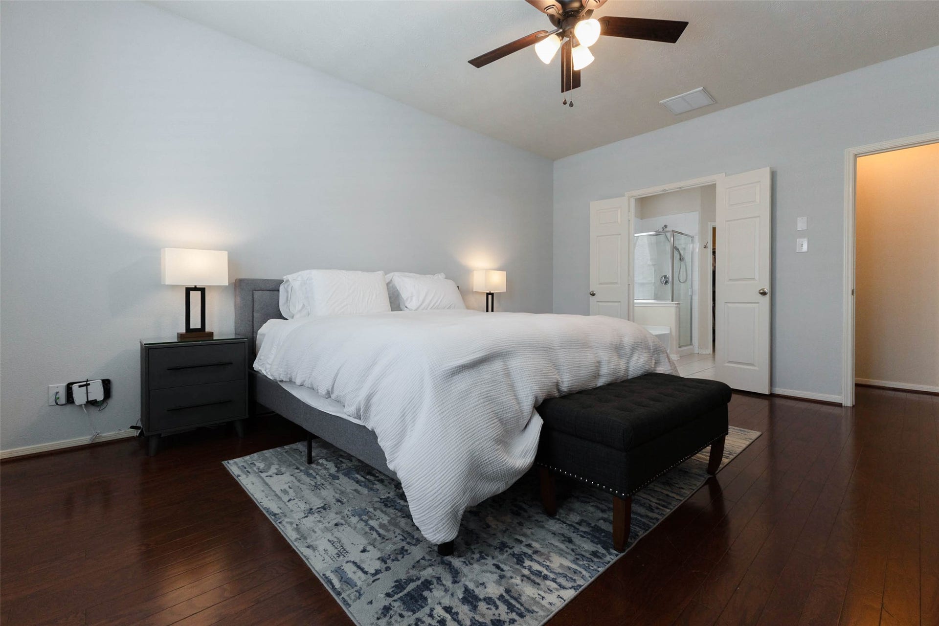 Another angle showcases the impressive scale of the primary bedroom, with plenty of space for substantial furnishings and even a separate sitting area if desired. Direct access to the ensuite bath completes this relaxing owners retreat.