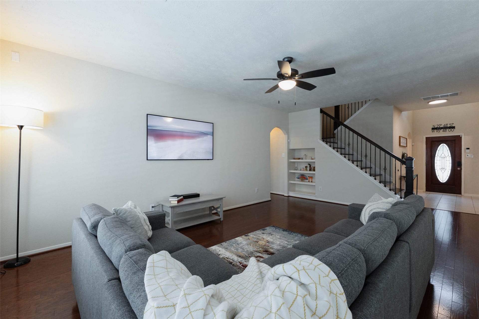 Spacious and comfortable, the family room provides plenty of room for substantial seating and multiple furniture arrangements. Rich wood flooring and neutral finishes create a warm backdrop, while built-in shelving offers an attractive place for books, dcor, and treasured collections.