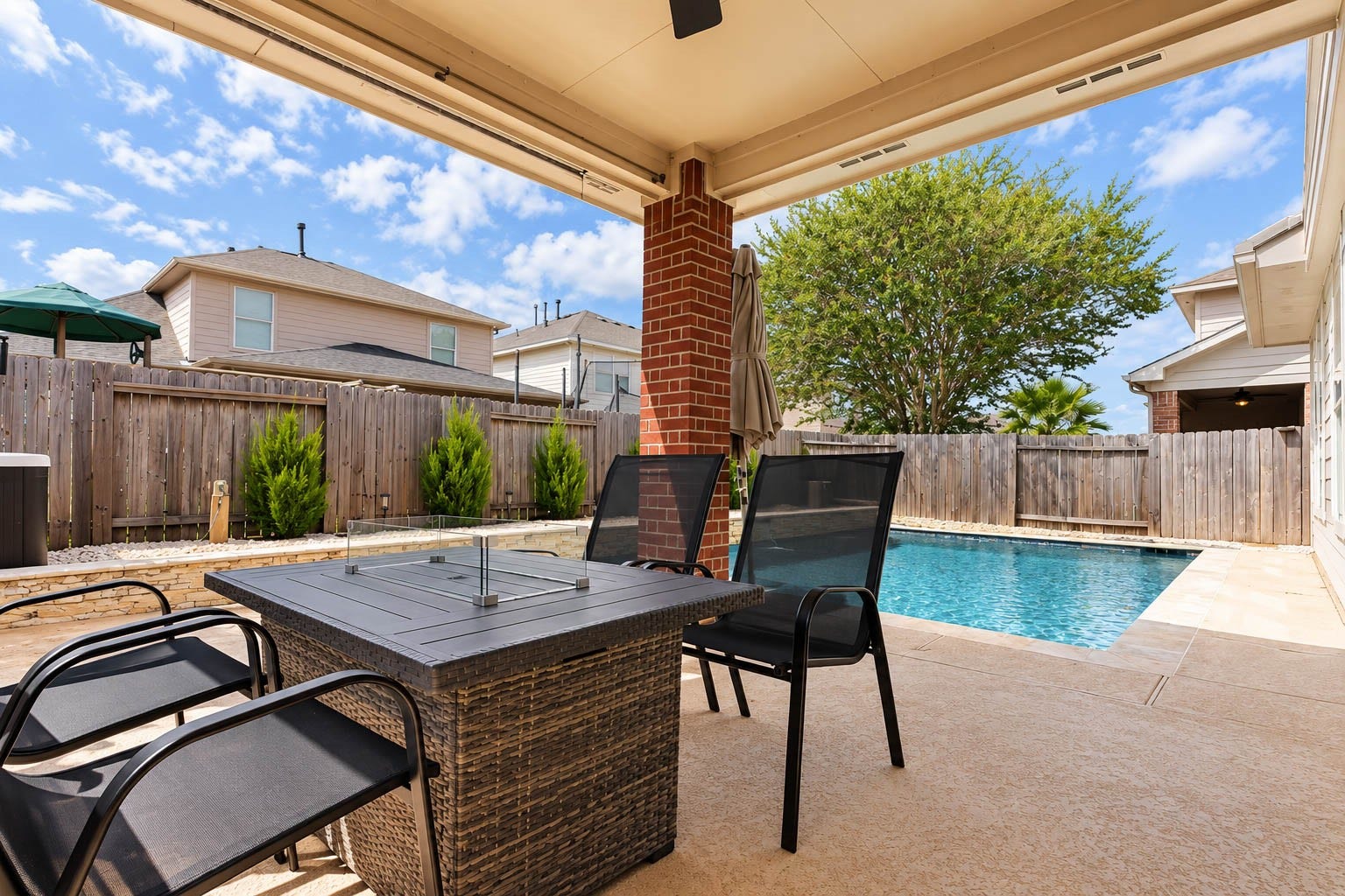 Step outside to a backyard designed for enjoying the Texas lifestyle. The covered patio creates a shaded outdoor dining and lounging area overlooking the sparkling pool.