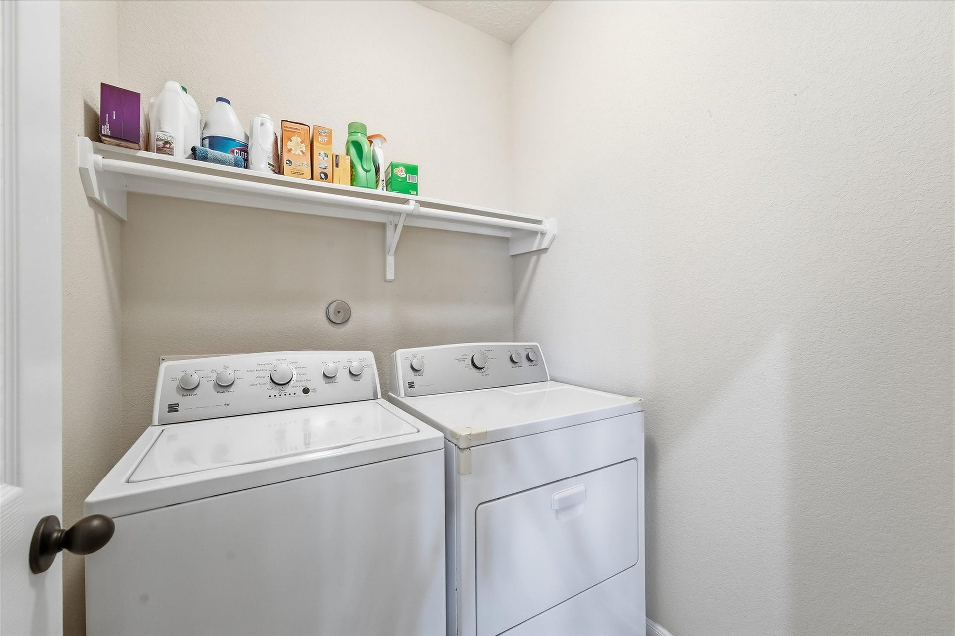 25522 Brentmoor Drive, Porter, TX 77365 Dedicated indoor utility room featuring upper built-in shelving and an integrated hanging rod for streamlined laundry days.
