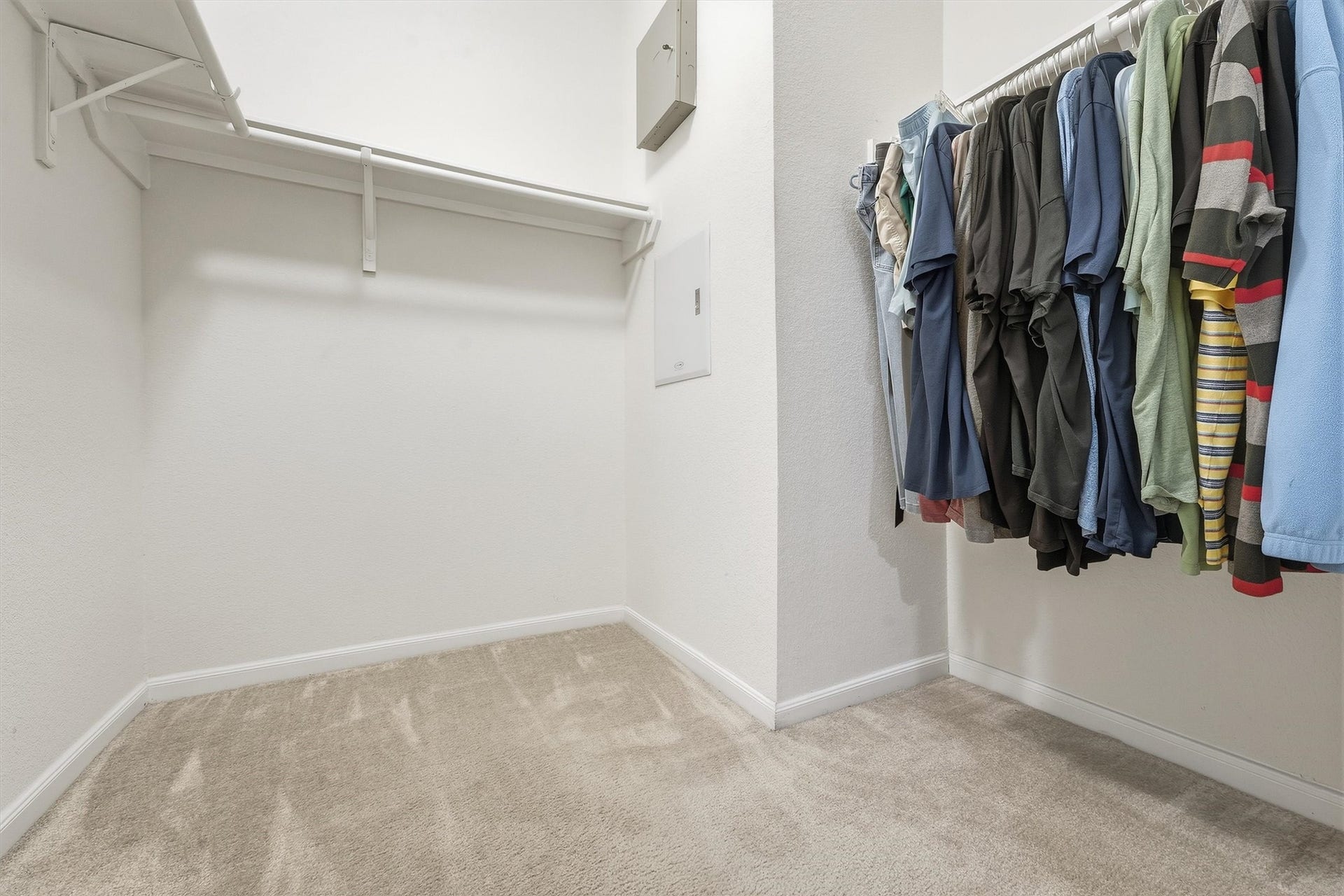 25522 Brentmoor Drive, Porter, TX 77365 Expansive walk-in closet featuring multi-wall built-in shelving, ample hanging rods, and plush neutral carpeting.