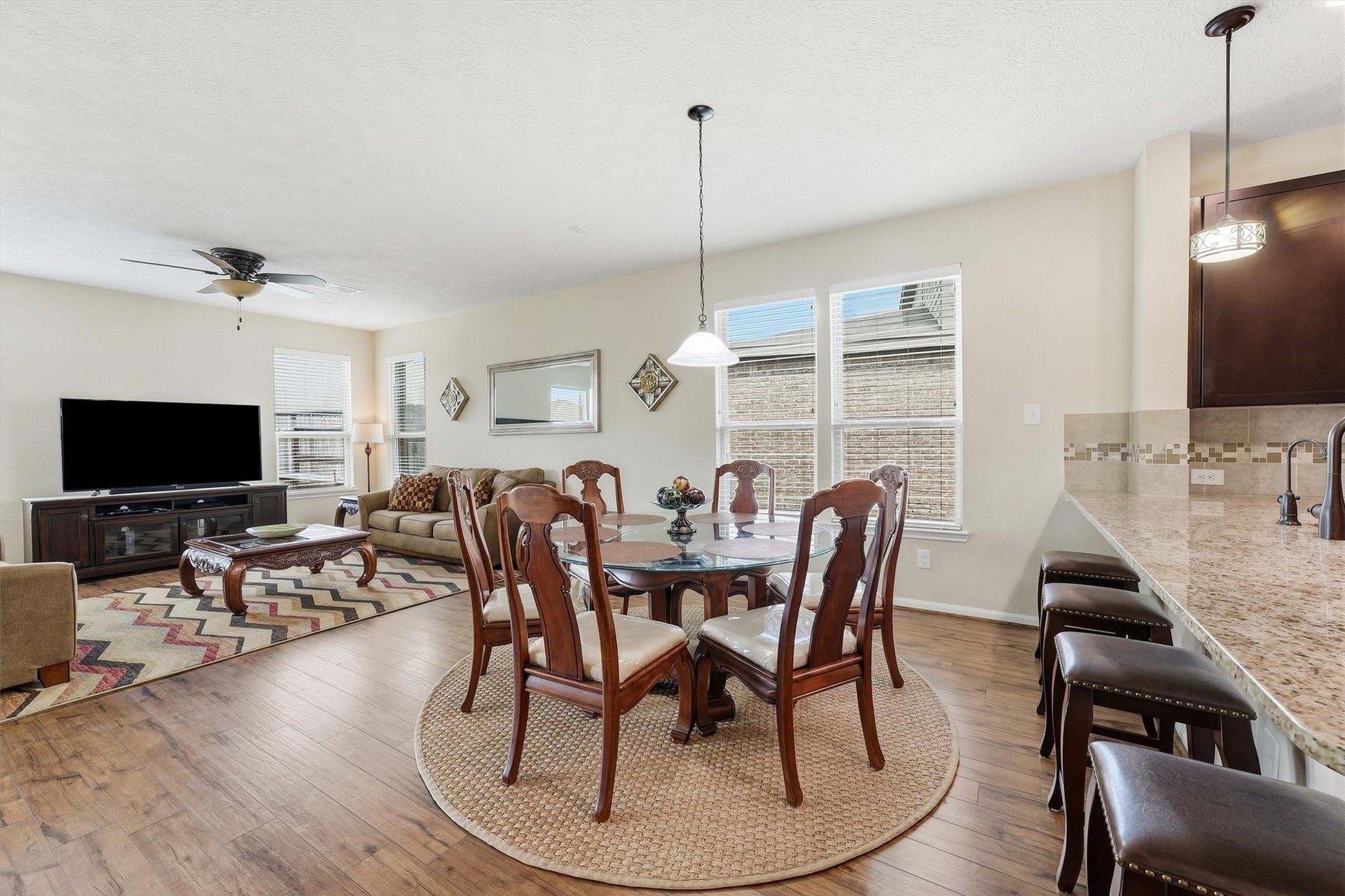 25522 Brentmoor Drive, Porter, TX 77365 Sunlit dining and living areas flow directly off the kitchen island breakfast bar, creating an open, flexible space for casual meals and gatherings.