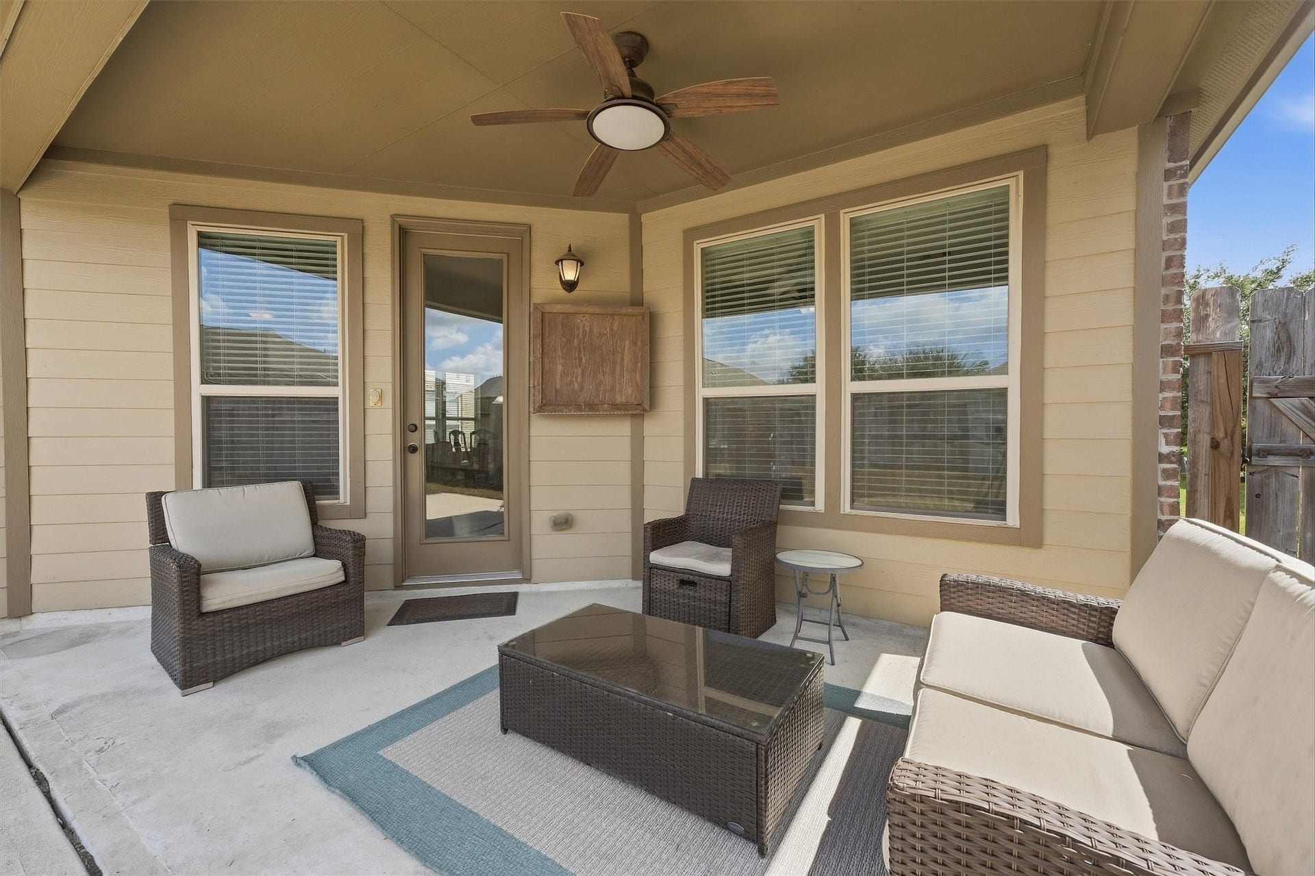 25522 Brentmoor Drive, Porter, TX 77365 Covered patio complete with an outdoor TV cabinet, ceiling fan, and an extended concrete pad offering extra space for grilling and lounge chairs.