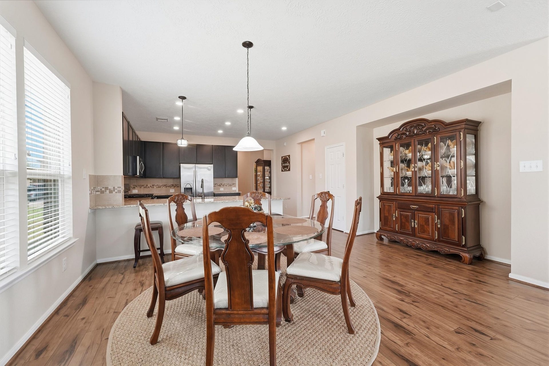 25522 Brentmoor Drive, Porter, TX 77365 Sunlit dining and living areas flow directly off the kitchen island breakfast bar, creating an open, flexible space for casual meals and gatherings.
