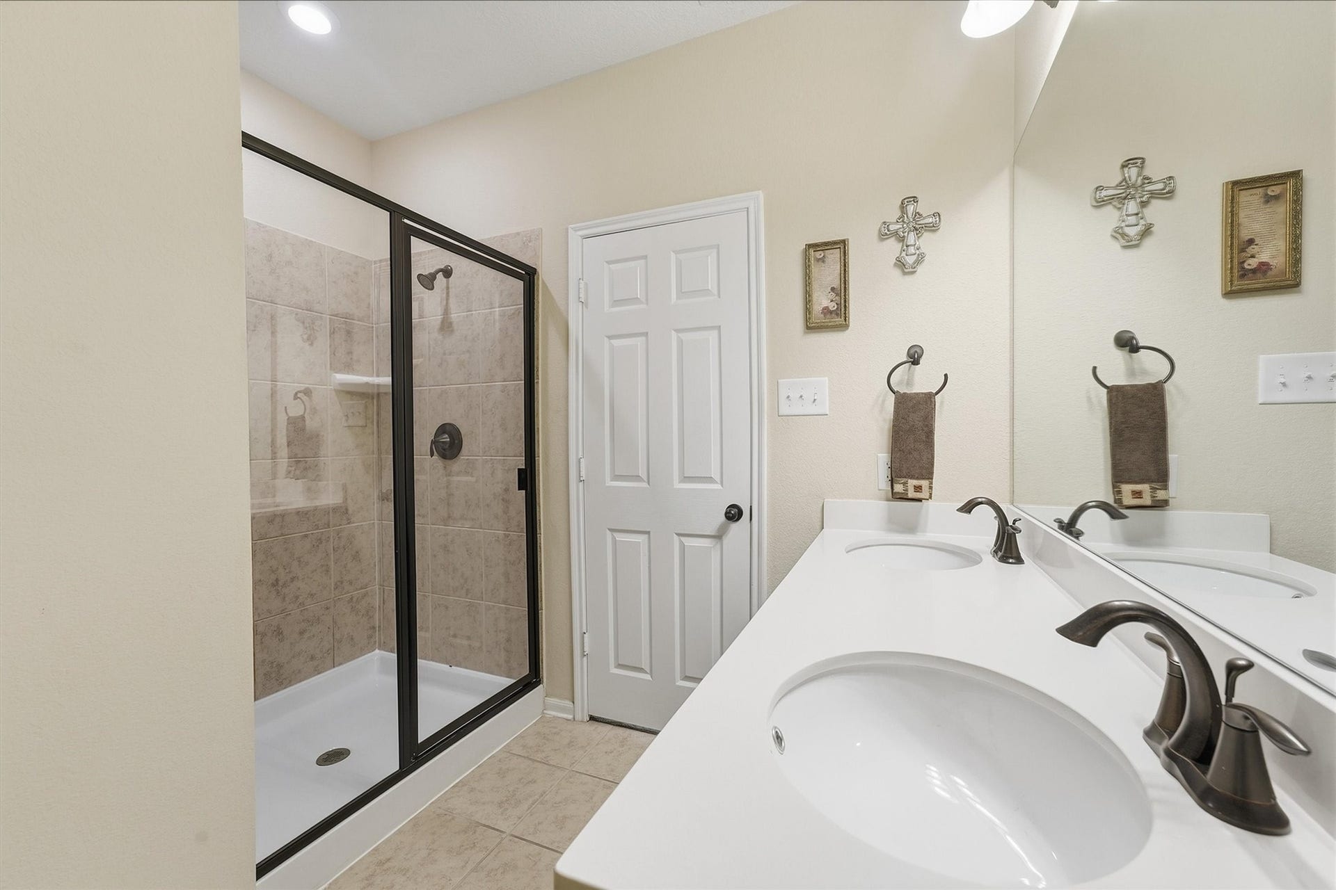 25522 Brentmoor Drive, Porter, TX 77365 Spacious bath en-suite featuring a modern vanity with oil-rubbed bronze fixtures and an oversized walk-in shower with tile surround and sliding glass doors.