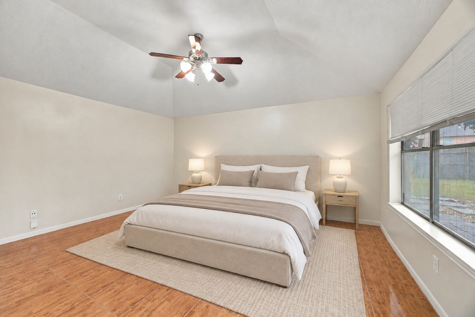 12902 Sandri Lane, Houston, TX 77077 The spacious primary bedroom features a raised ceiling, a ceiling fan, and room for a variety of furniture arrangements. Virtually staged