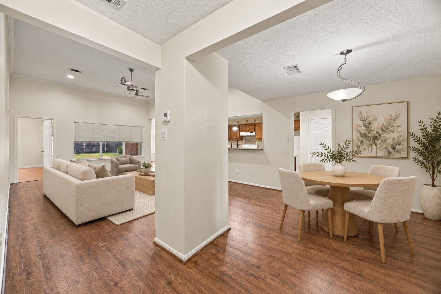 12902 Sandri Lane, Houston, TX 77077 Wide openings connect the dining and living areas, while a kitchen pass-through keeps the spaces connected. Virtually staged