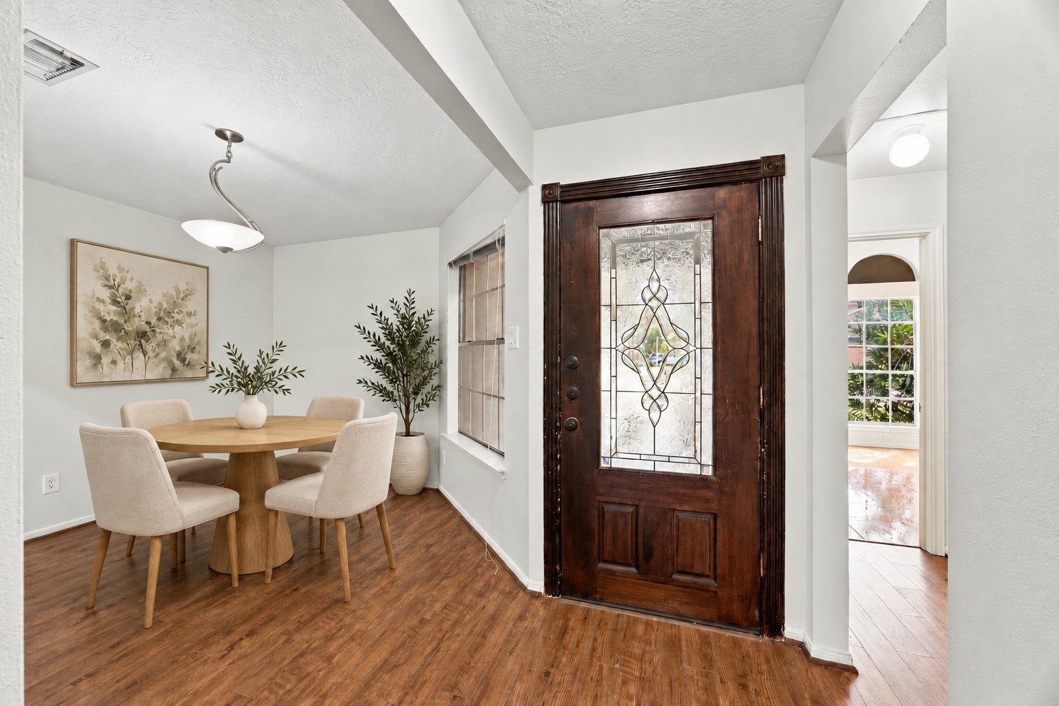 12902 Sandri Lane, Houston, TX 77077 The entry opens to a formal dining room with wood-look flooring flowing throughout. Virtually staged.