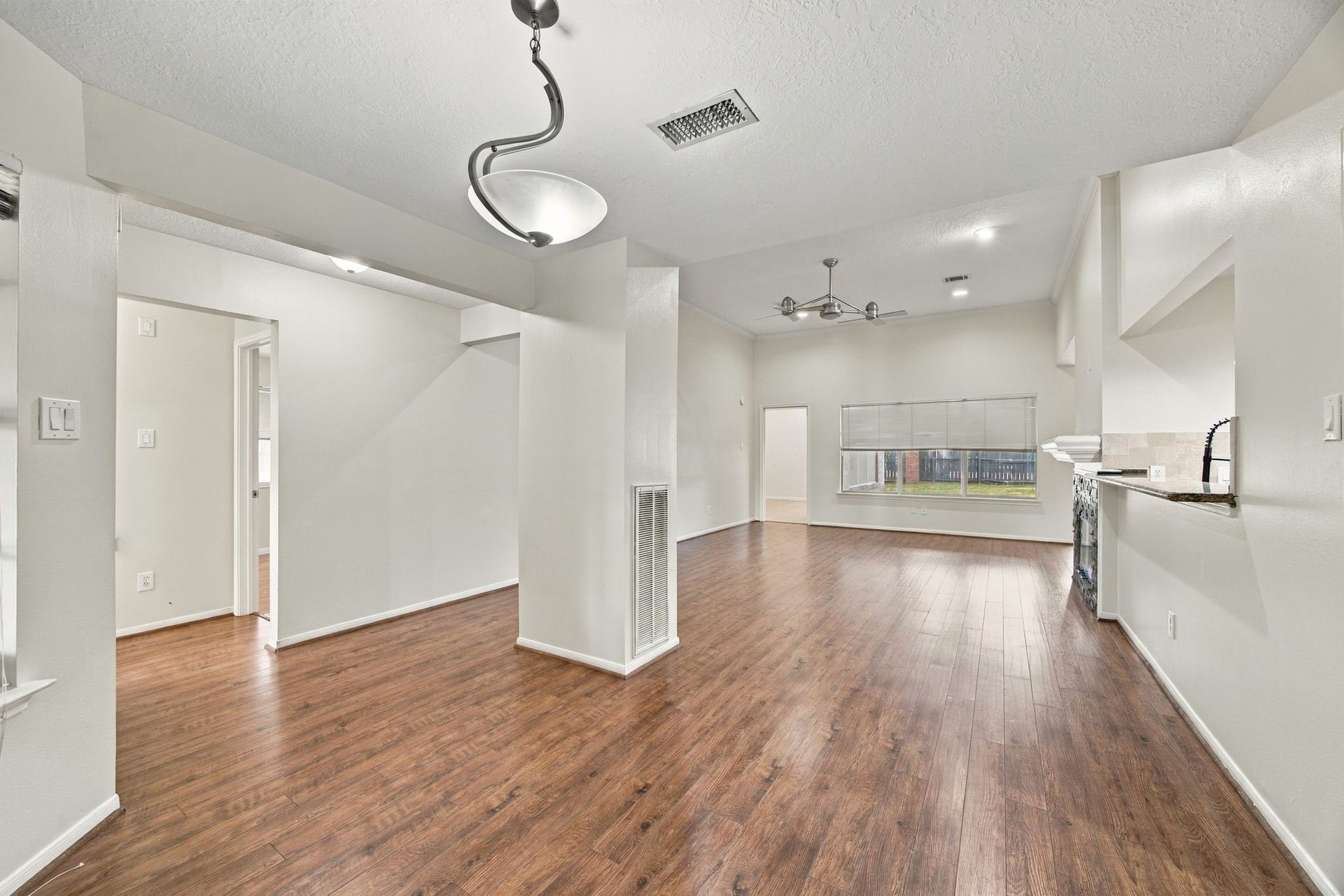 12902 Sandri Lane, Houston, TX 77077 This view highlights the flow from the front dining area toward the living room, with the kitchen alongside
