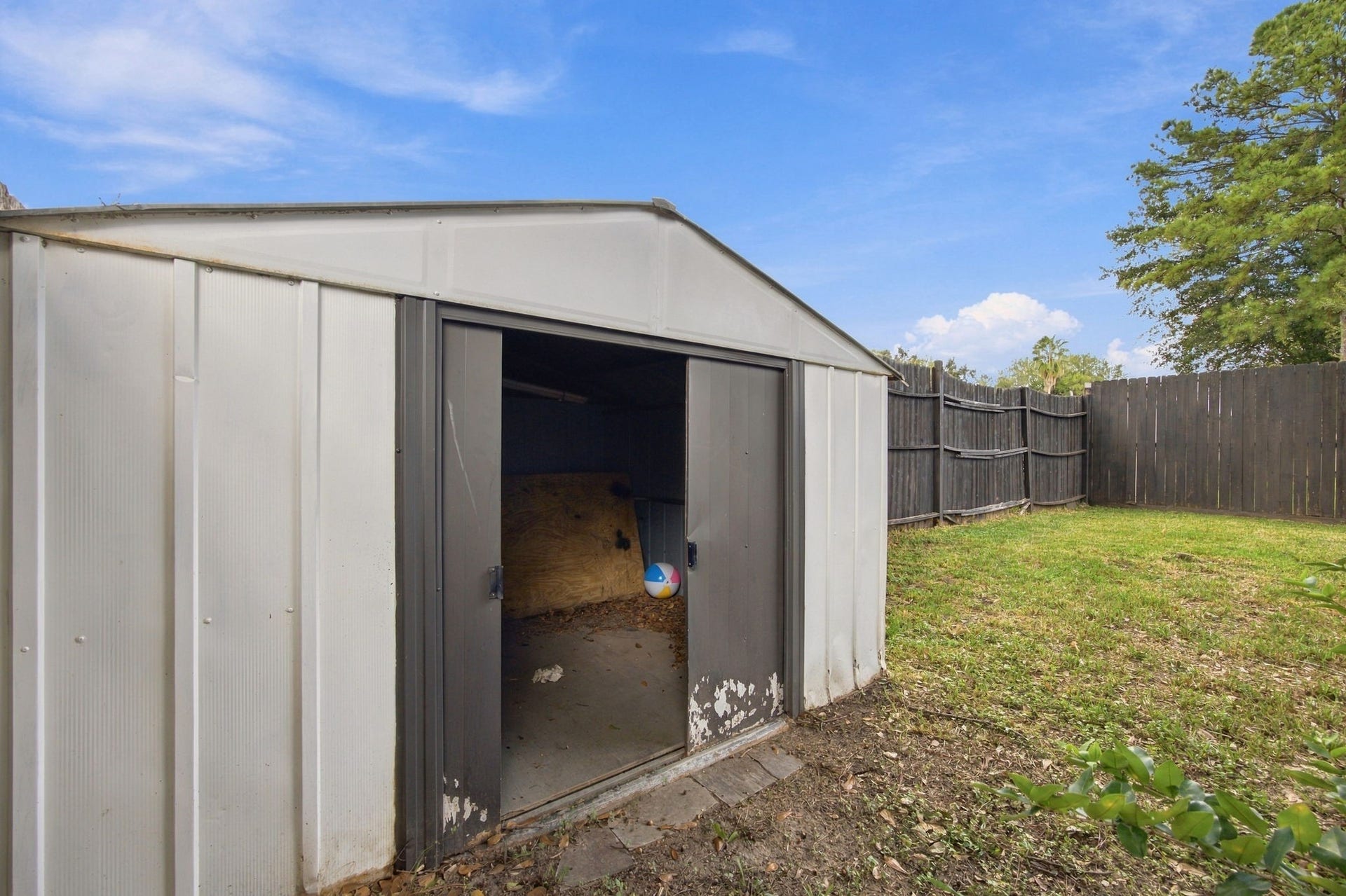 12902 Sandri Lane, Houston, TX 77077 A backyard storage shed provides additional space for lawn equipment, gardening tools, and outdoor supplies.