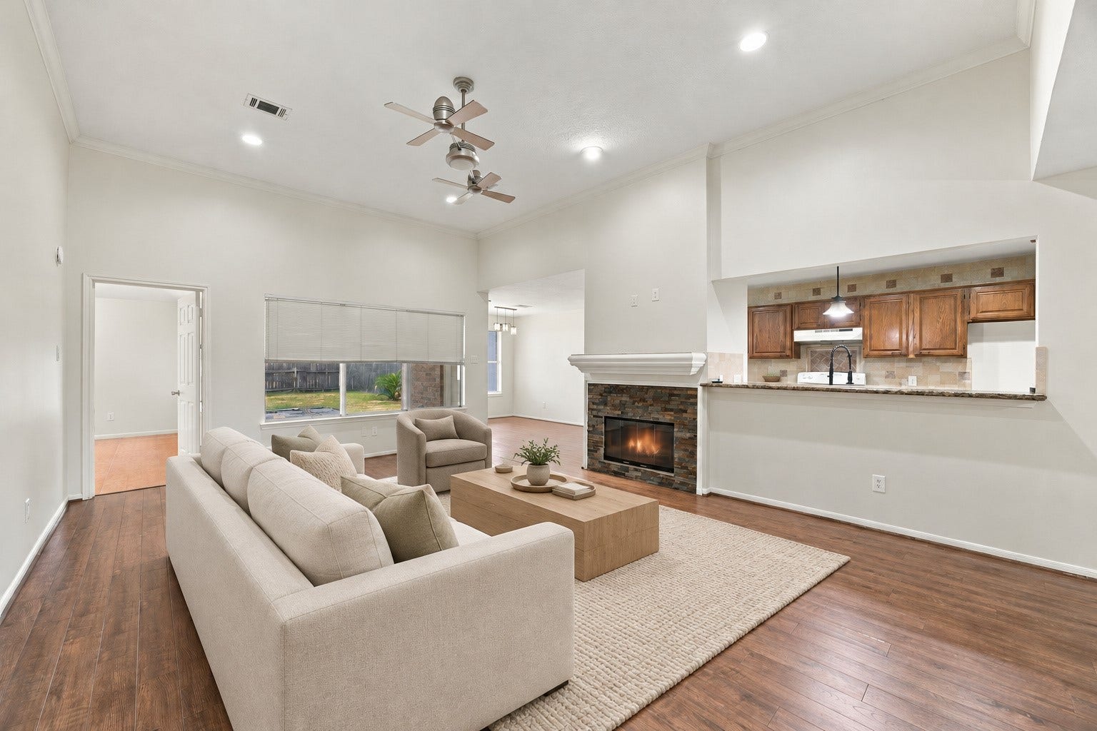 12902 Sandri Lane, Houston, TX 77077 A stone-faced fireplace anchors the living room, and the broad kitchen opening makes conversation easy. Virtually staged.