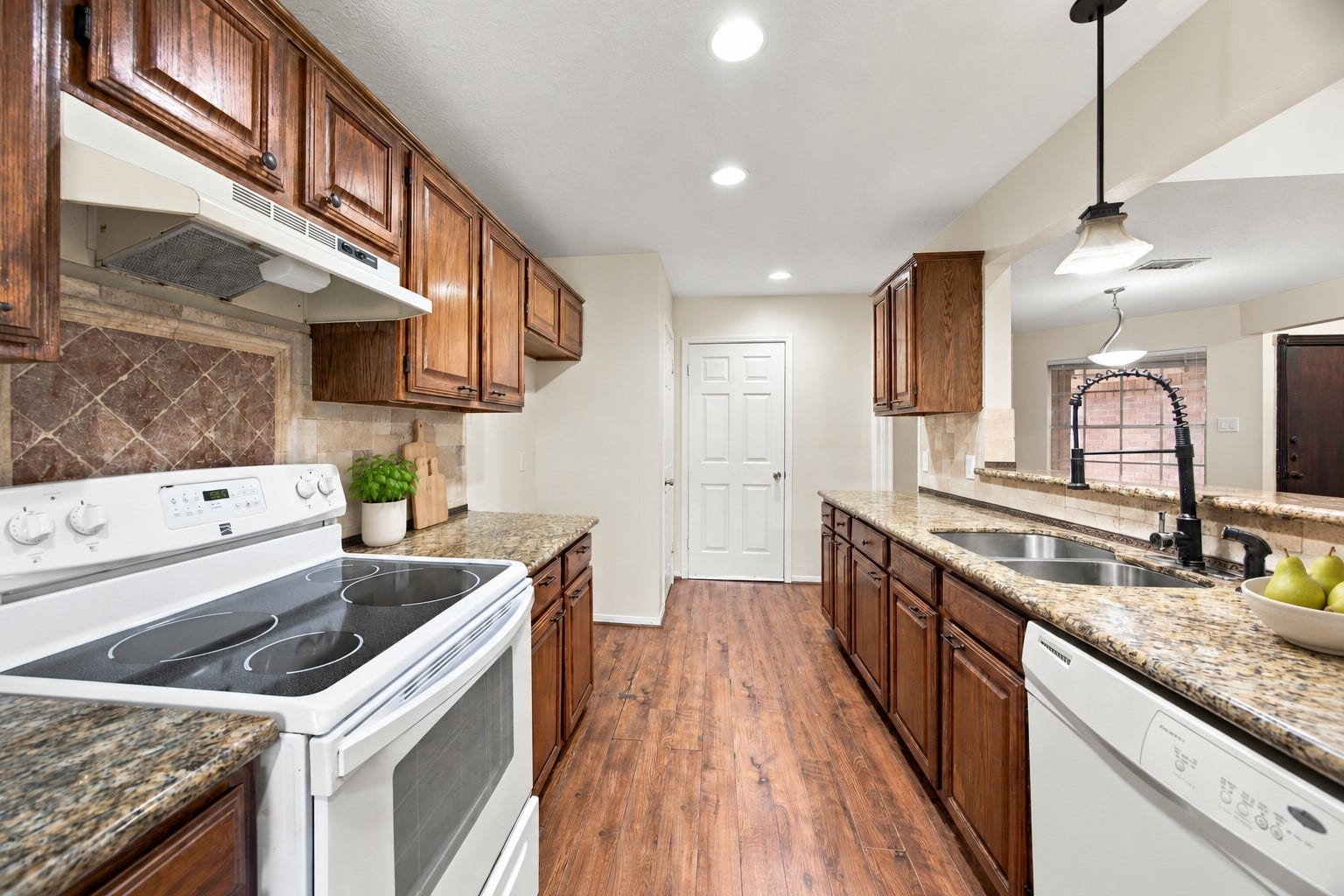 12902 Sandri Lane, Houston, TX 77077 Generous counter space and upper and lower cabinetry provide plenty of room for meal preparation and storage. Virtually staged