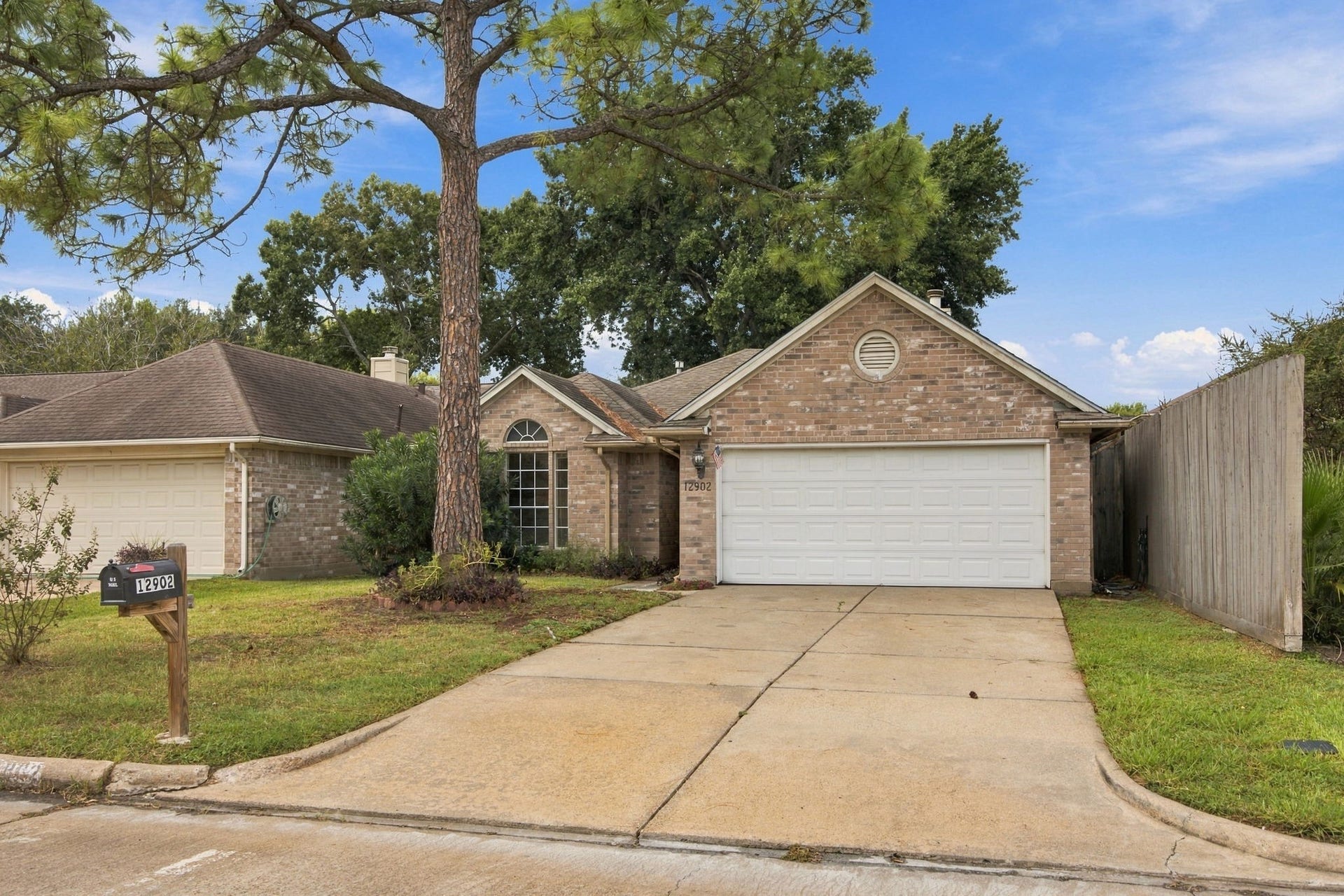 12902 Sandri Lane, Houston, TX 77077 A double-width driveway leads to the garage, providing convenient off-street parking.