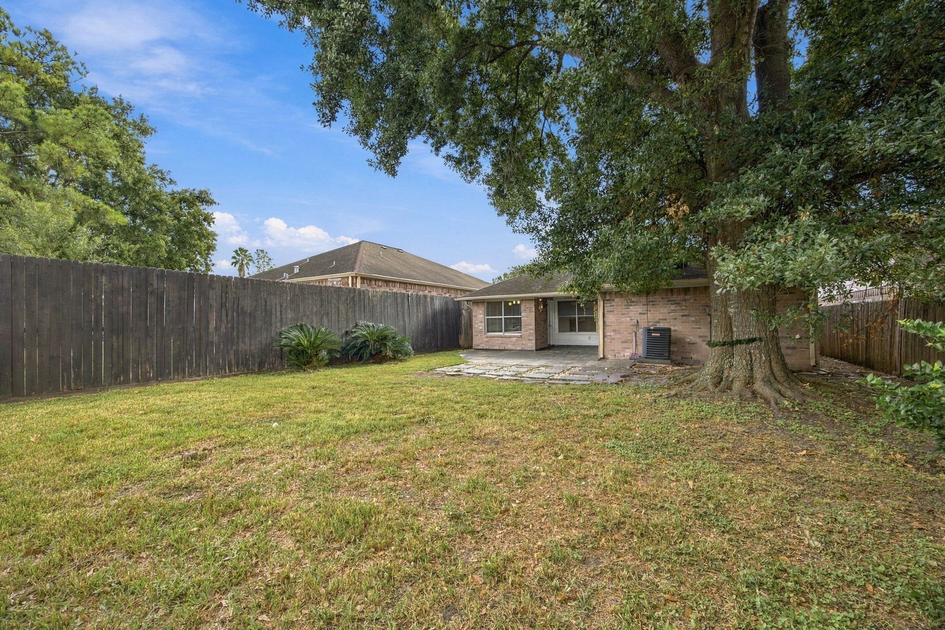 12902 Sandri Lane, Houston, TX 77077 A mature shade tree anchors the lawn, with open space to create your own outdoor retreat.