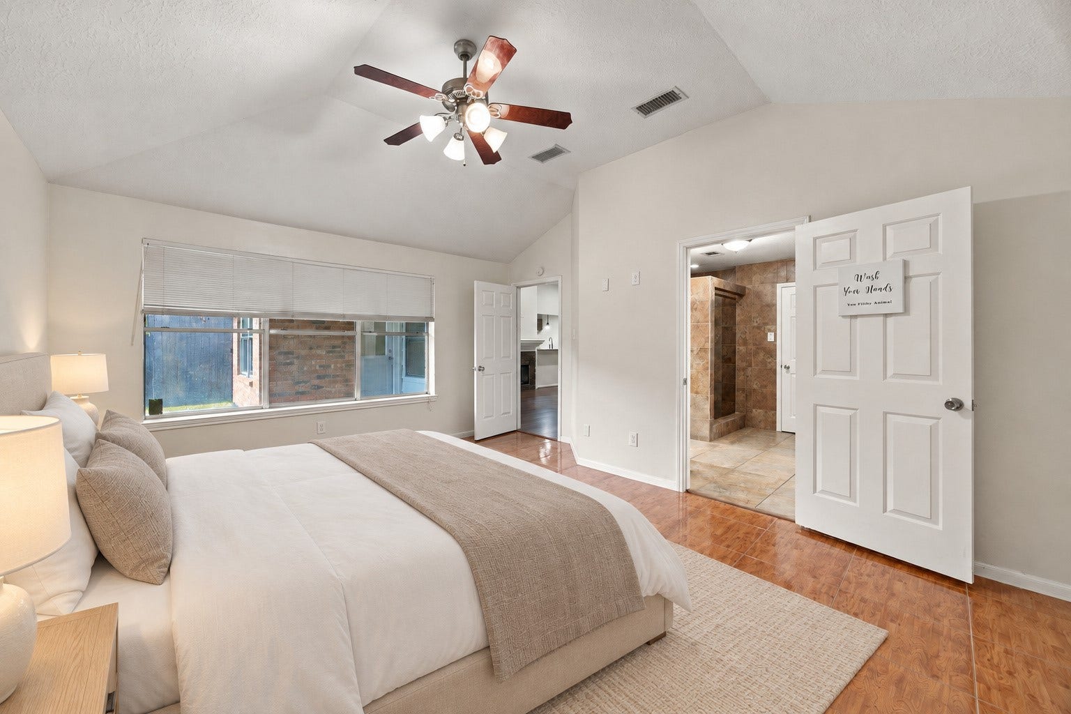 12902 Sandri Lane, Houston, TX 77077 A wide window welcomes natural light, while the adjoining bathroom is easily accessible from the bedroom. Virtually staged