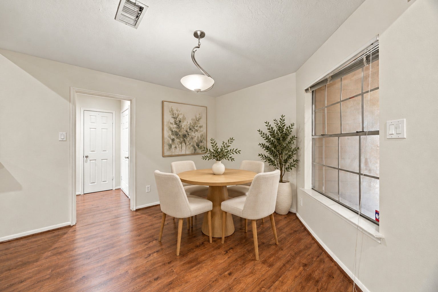 12902 Sandri Lane, Houston, TX 77077 A front-facing window and overhead light define a comfortable spot for a dining table.Virtually staged