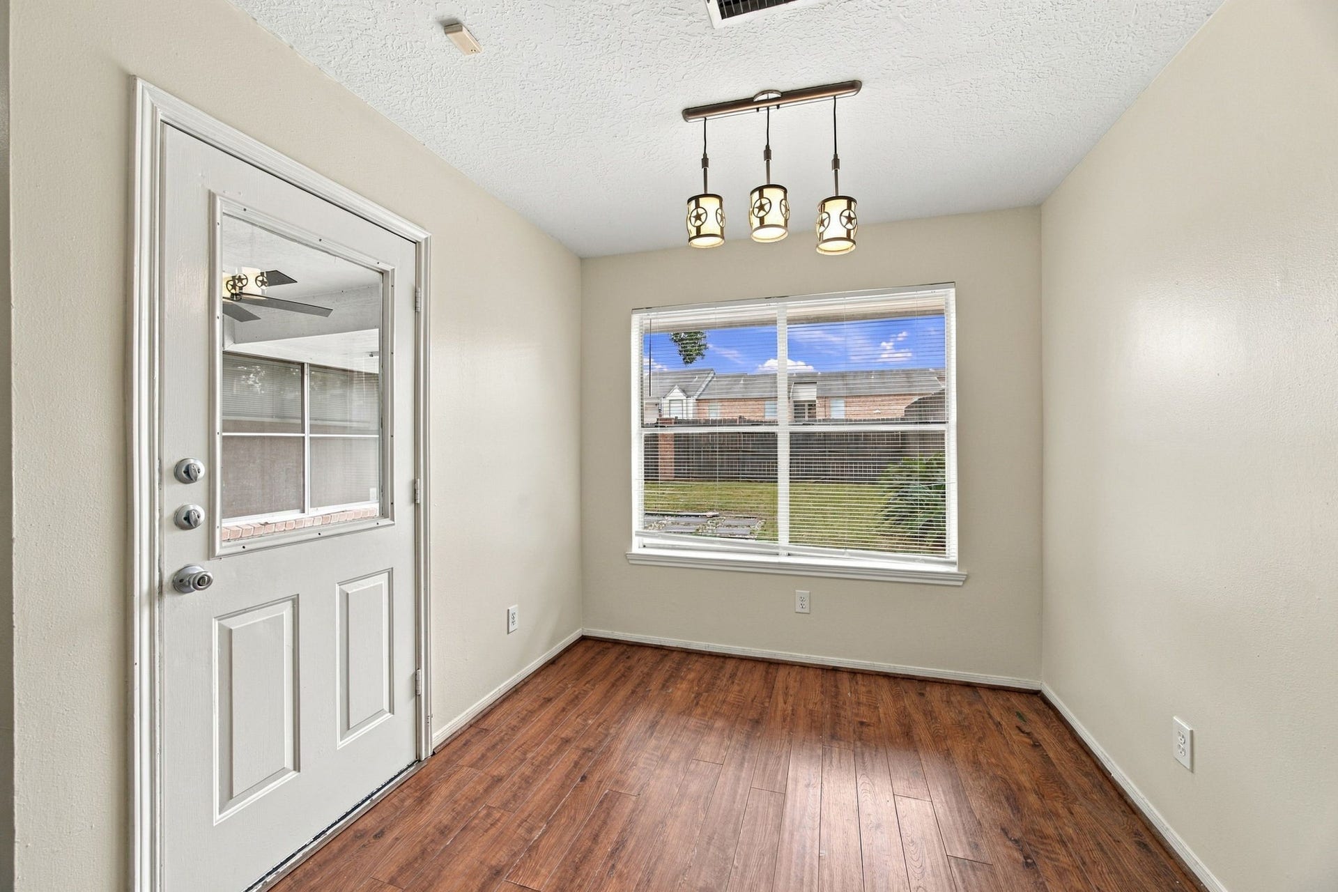 12902 Sandri Lane, Houston, TX 77077 A sunny breakfast nook offers a casual dining spot beside a large window and an exterior door.