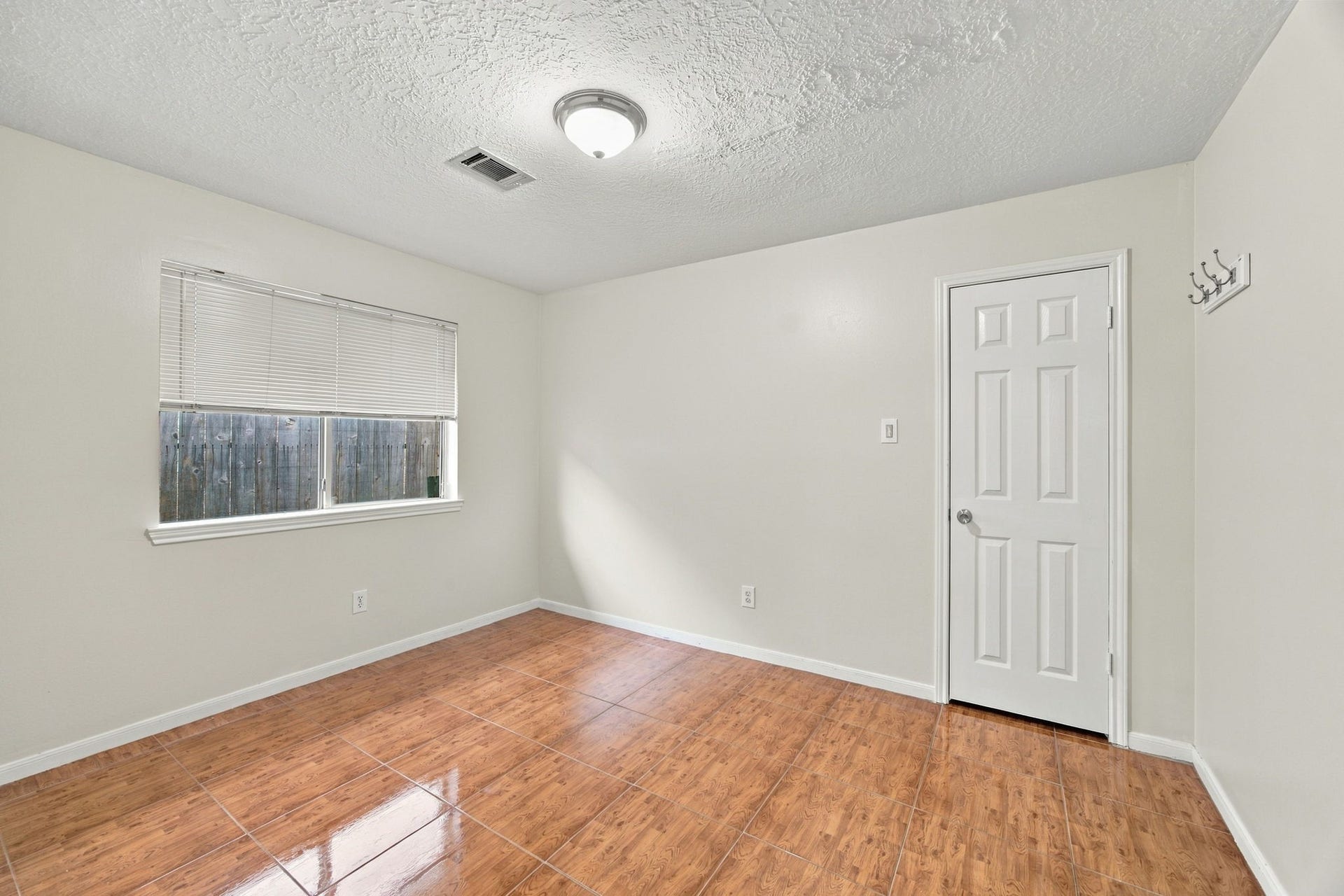 12902 Sandri Lane, Houston, TX 77077 Natural light and wood-look flooring create a welcoming bedroom that could also serve as a home office or guest room.