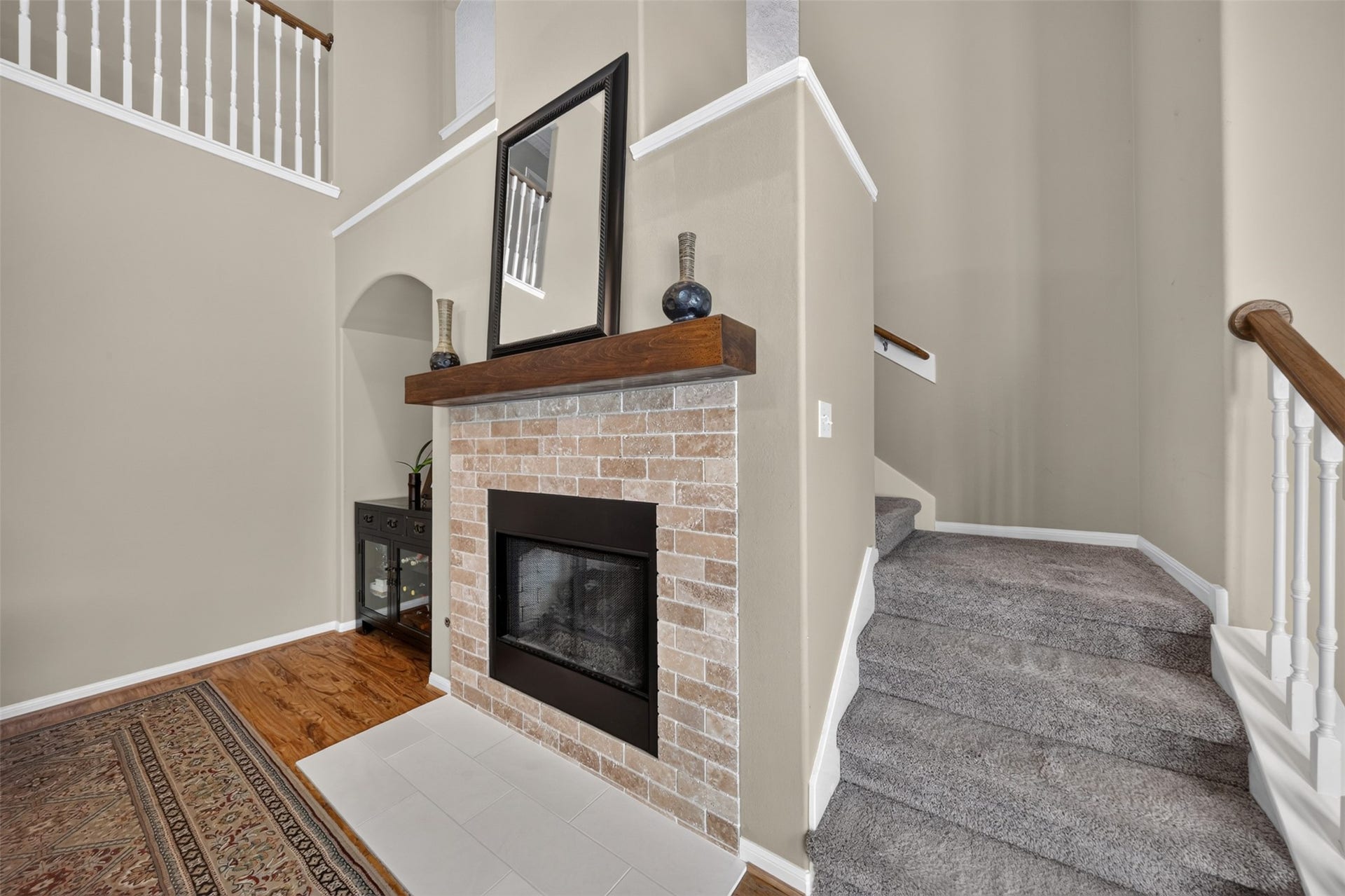 127 N Hawthorne Hollow Circle, The Woodlands, TX 77384 Updated fireplace featuring a refreshed surround, hearth, and wood mantel, creating a warm focal point in the living space.