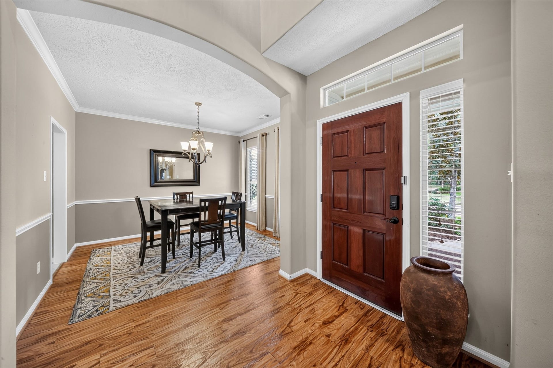 127 N Hawthorne Hollow Circle, The Woodlands, TX 77384 Welcoming entry with warm beautiful floors, natural light, and an open view into the dining area.
