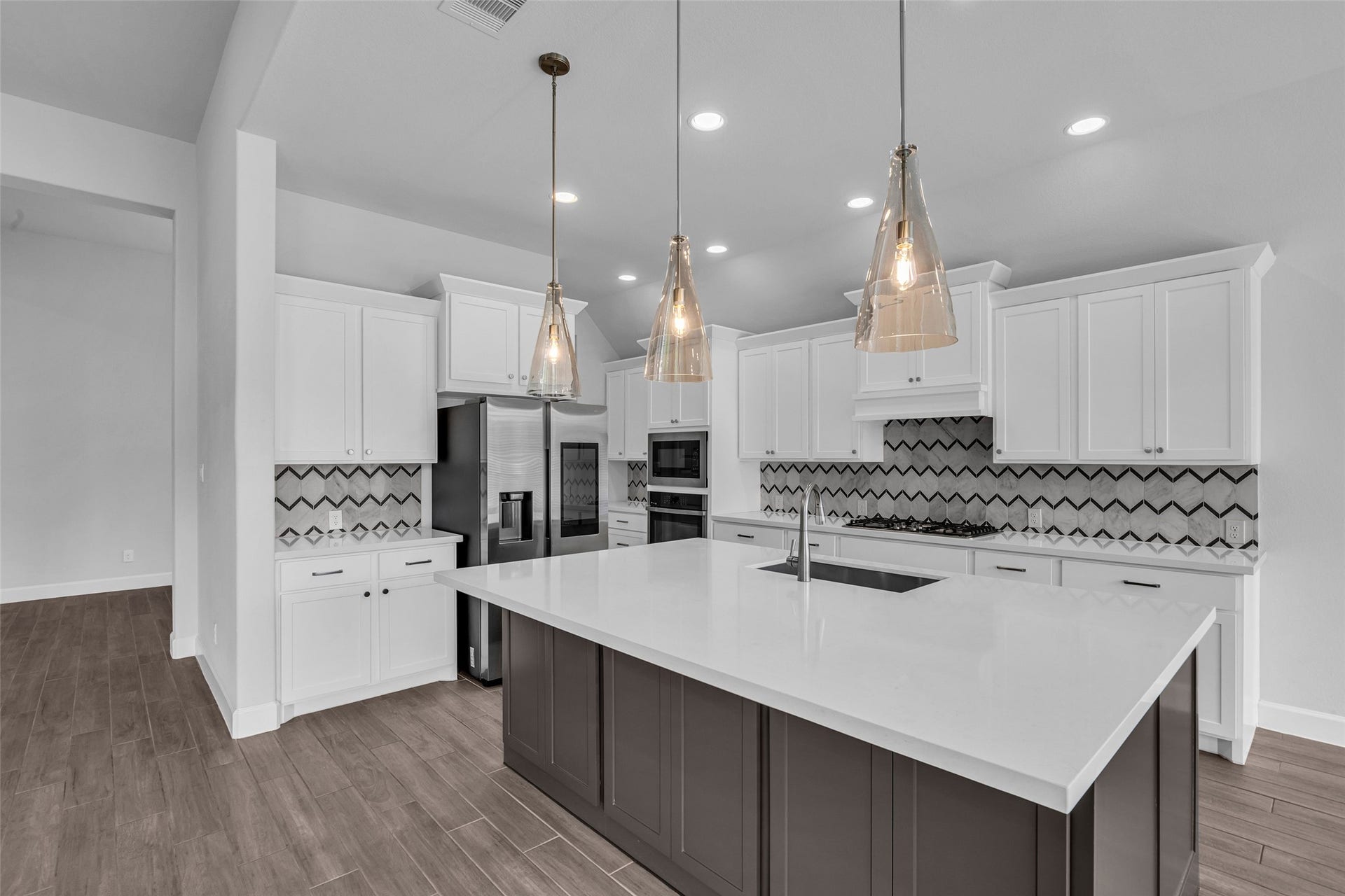 2215 Carrol Creek Drive, Richmond, TX 77469 Island kitchen with upgraded stone and backsplash