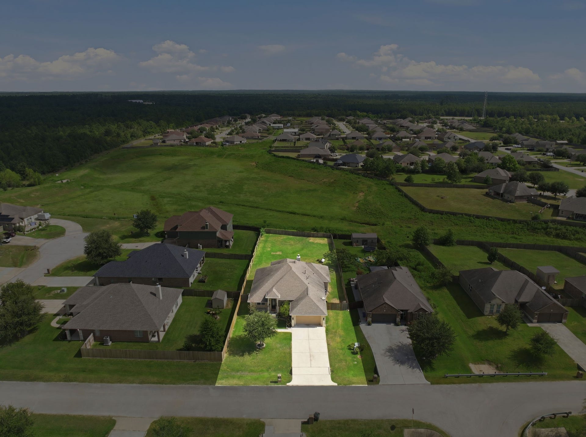 18818 Wichita Trail, Magnolia, TX 77355 Aerial view highlights the oversized lot of 18818 Wichita Trail, showcasing its sprawling backyard with no back neighbors.