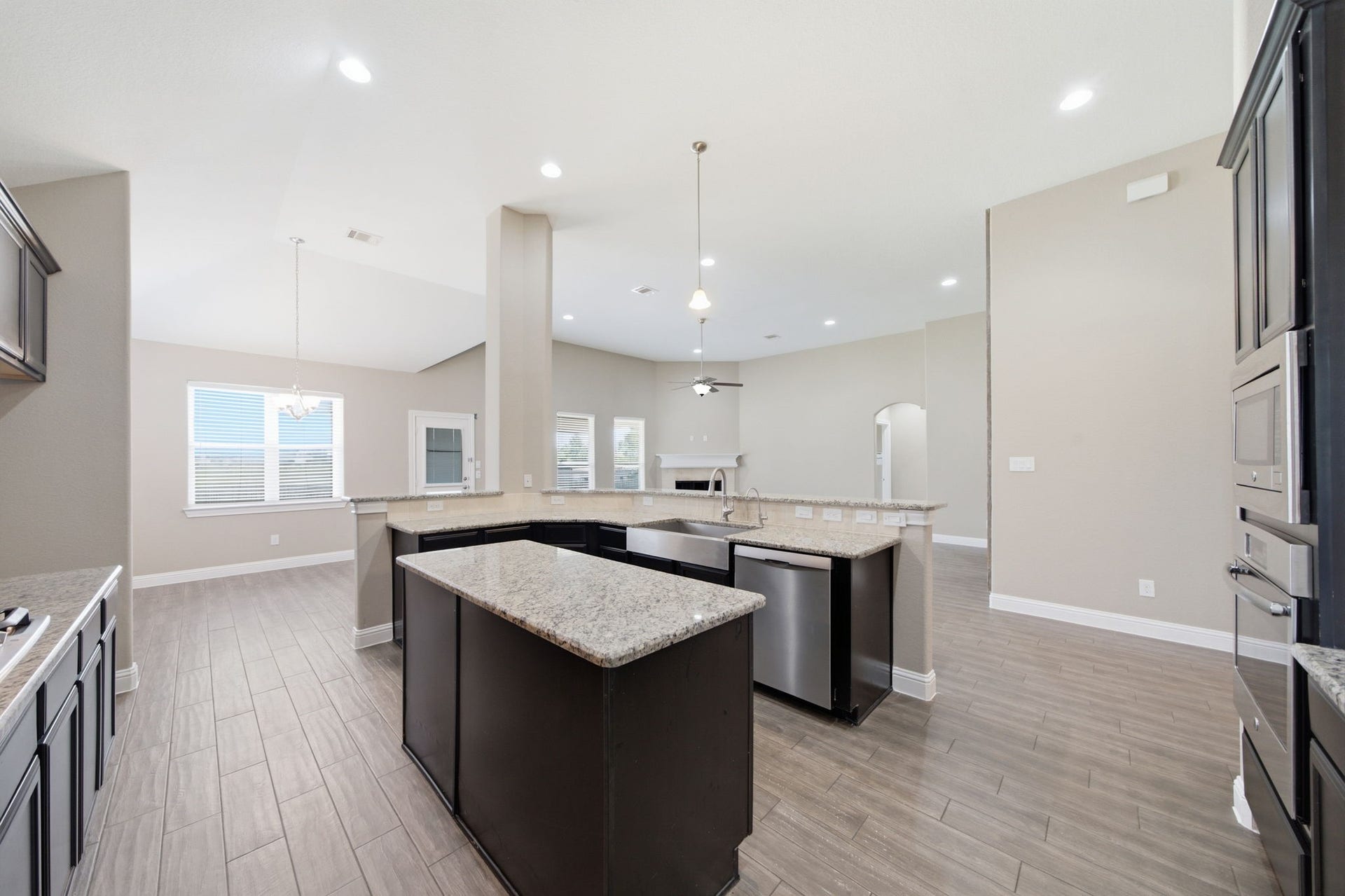 18818 Wichita Trail, Magnolia, TX 77355 Stunning granite countertops, a central island, and stainless steel appliances anchor this open-concept kitchen. The raised breakfast bar overlooks the adjoining living room, while the adjacent breakfast area sits conveniently nearby.