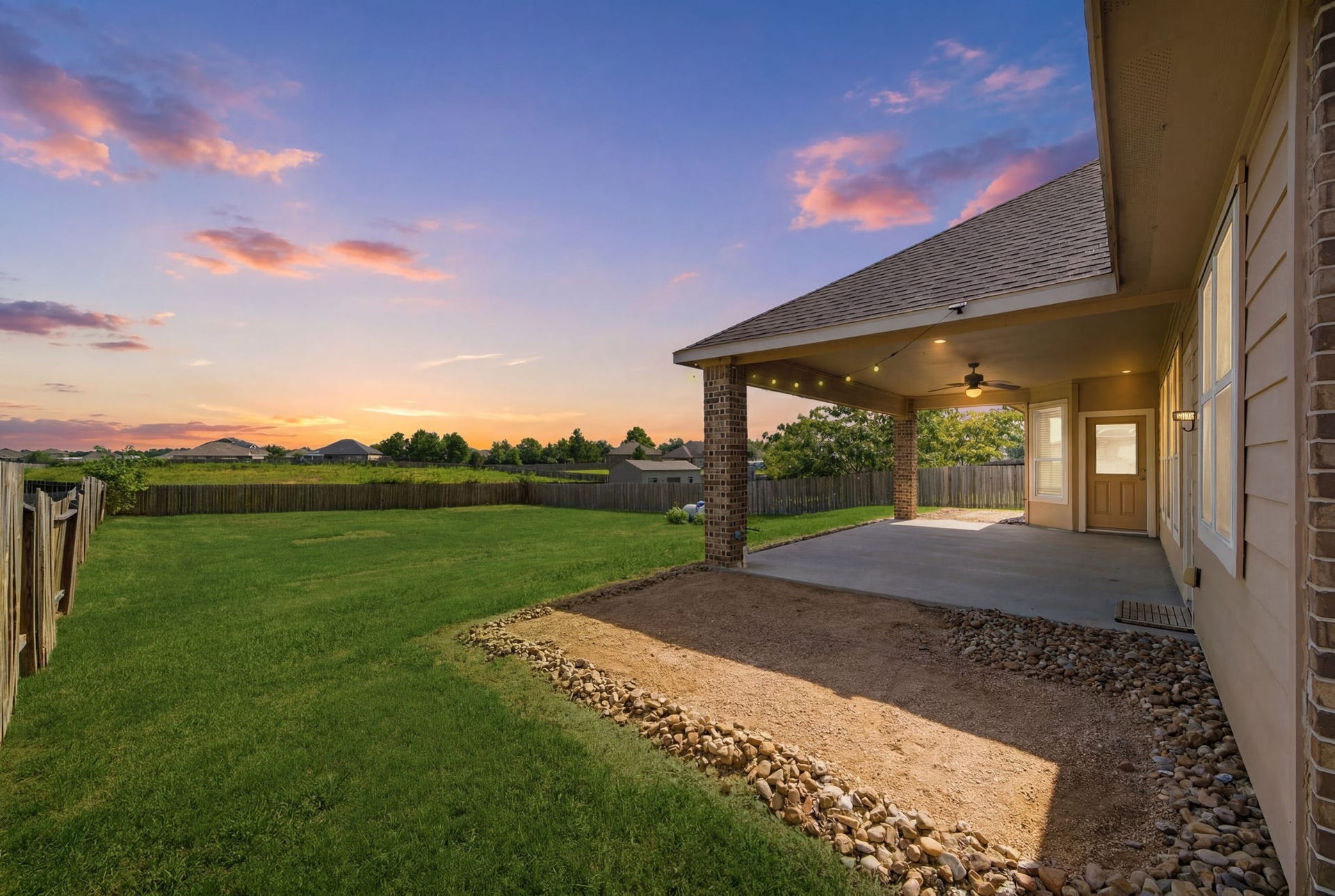 18818 Wichita Trail, Magnolia, TX 77355 Spacious back patio under a vaulted roof with brick columns overlooks an expansive, private fenced backyard. An oversized lot offers ample space for a pool or a lush garden with no back neighbors.