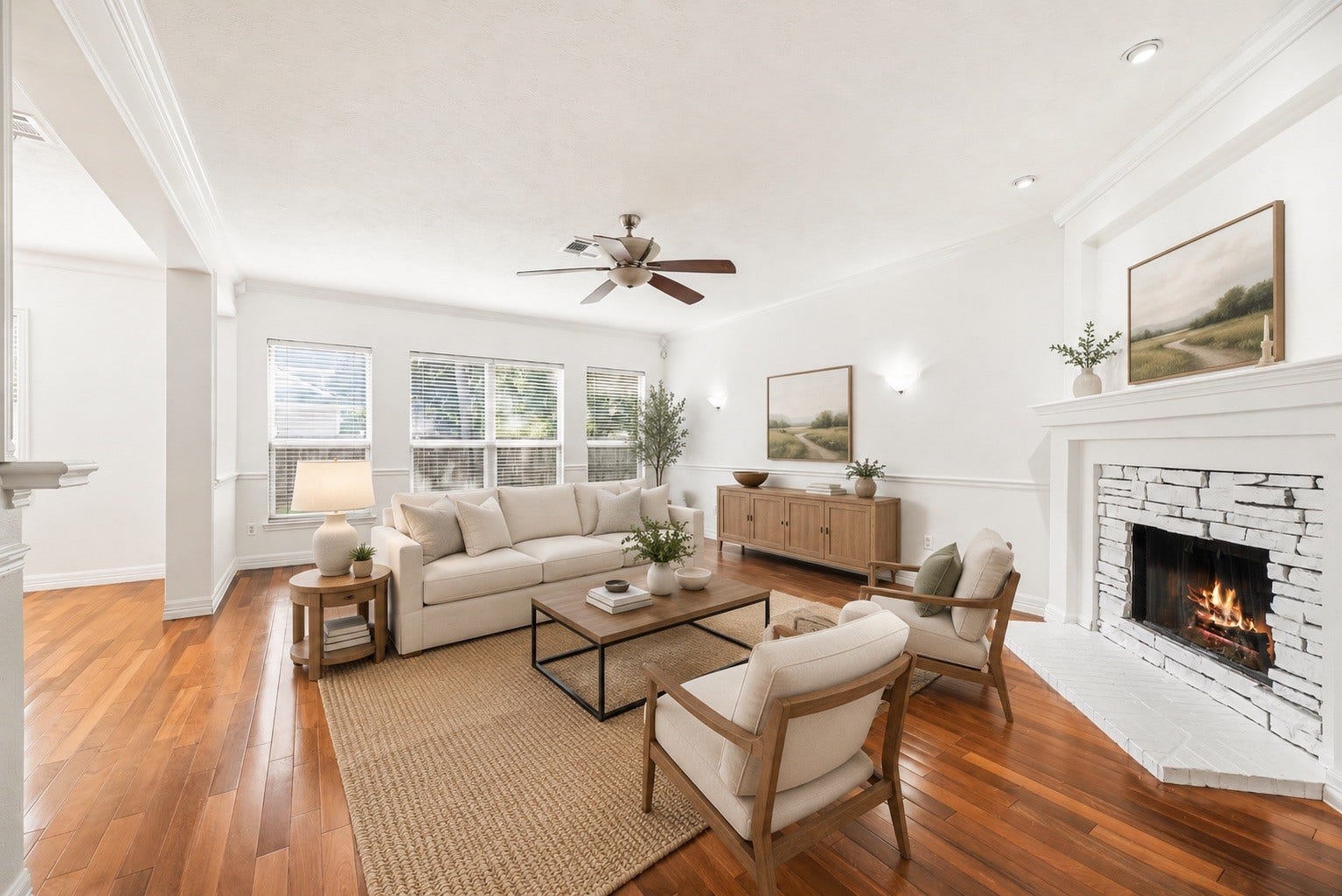 3422 Powell Way, Missouri City, TX 77459 Bright and energizing living room, featuring ceiling fan, beautiful fireplace, wood floors, and fresh paint. *virtually staged*