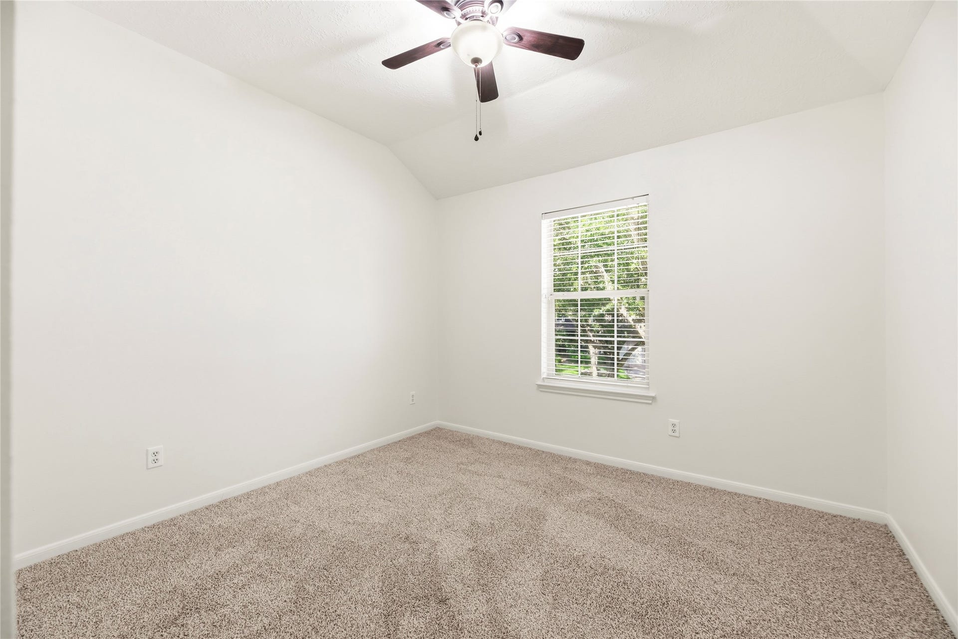 3422 Powell Way, Missouri City, TX 77459 Spacious secondary bedroom with brand new carpet, a ceiling fan, and fresh paint.