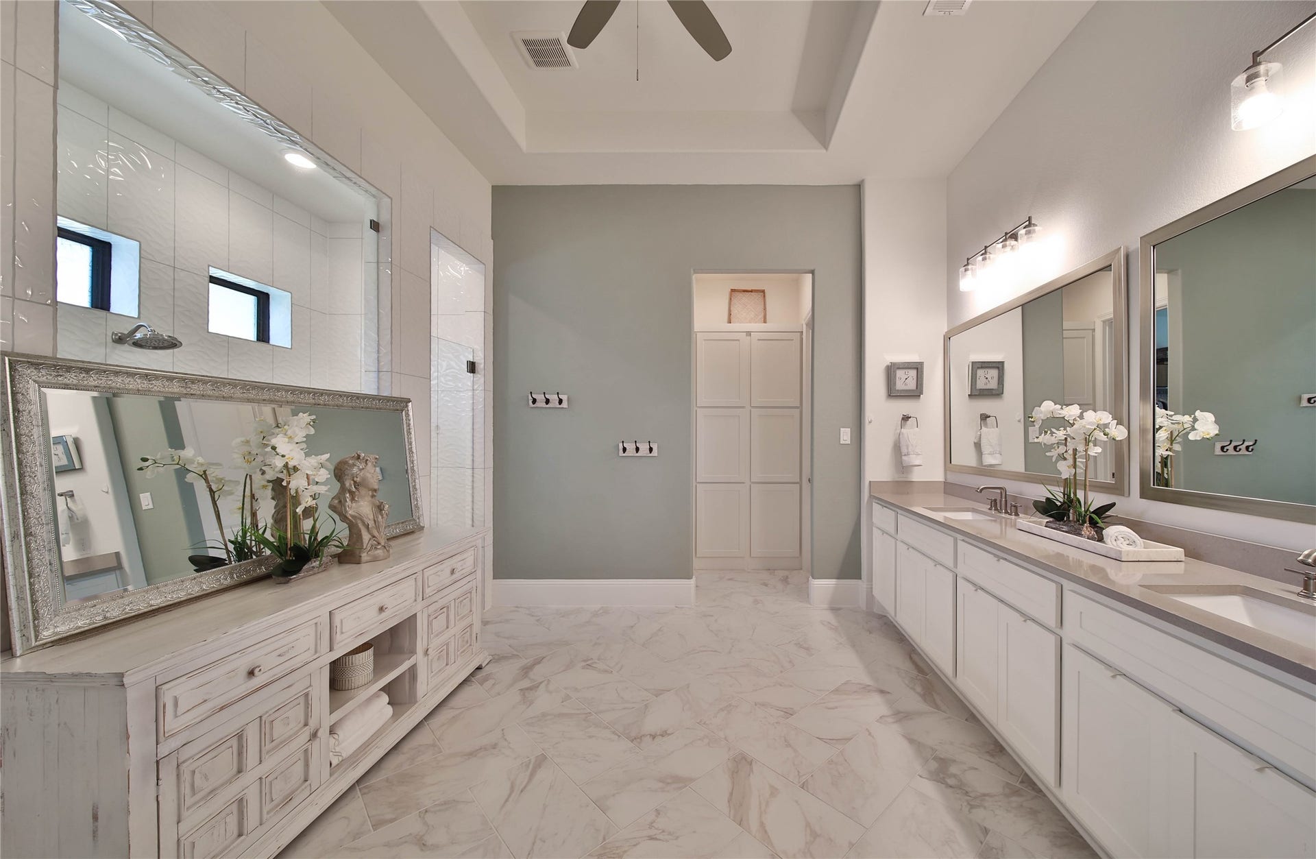 A luxurious primary bath offers plenty of space for two, creating a comfortable and inviting setting to start the day.