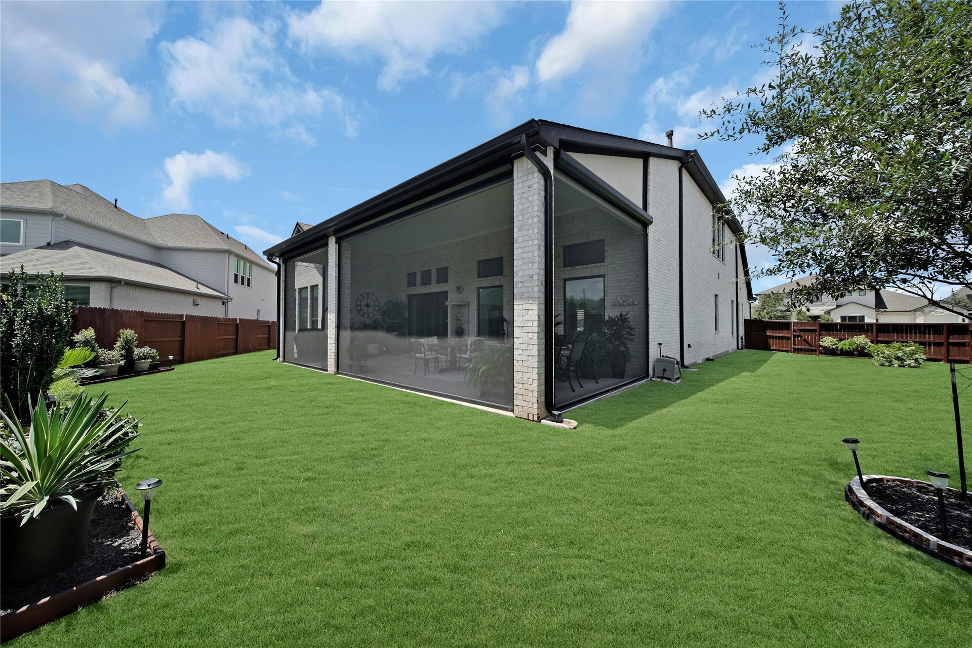 The back patio features remote-controlled screens divided into four customizable zones, allowing you to enjoy them fully open, fully closed, or anywhere in between.